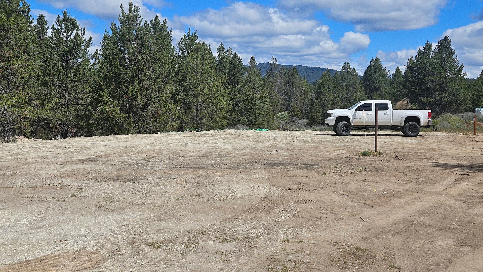 Pole is RV dump site. Electric hook up on left side of truck. Water hookup on right side if truck. Truck is where you park your RV. It overlooks the creek. 