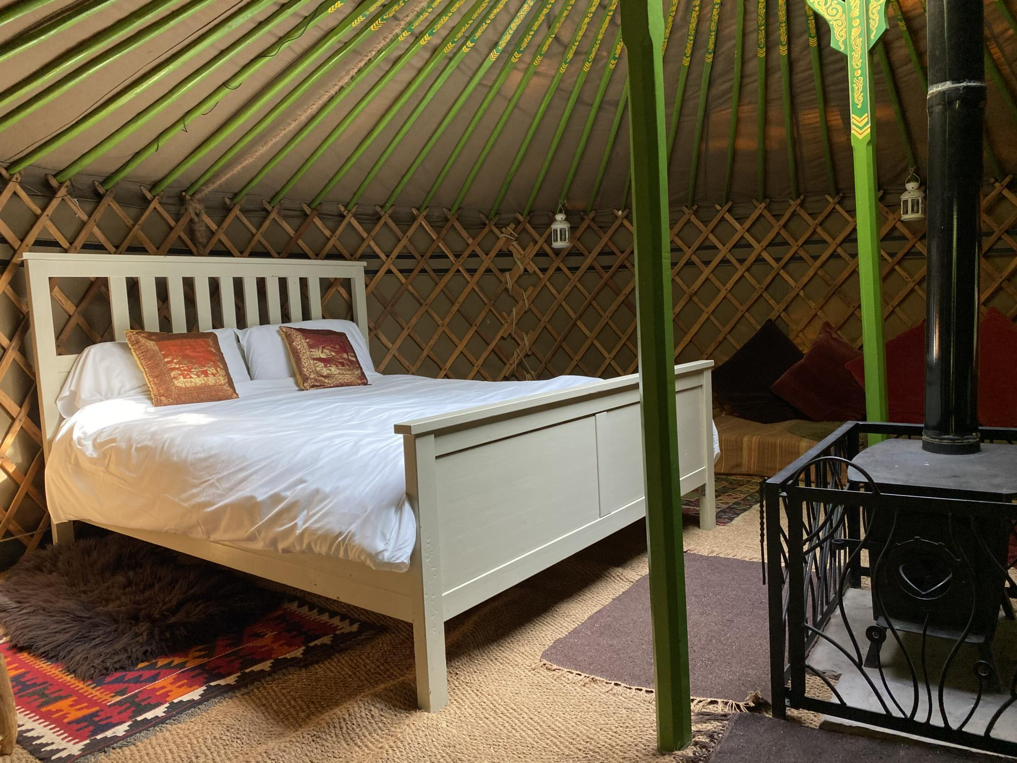 Oak Yurt with a very comfy king sized bed and single mattresses for the kids