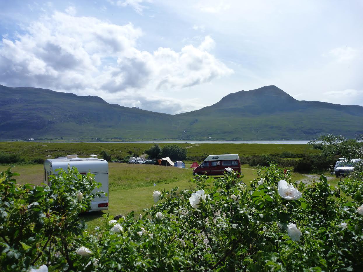 A grass pitch with Electric Hookup at Badrallach. Bring a campervan to this lochside loaction in Scotland, plug in and switch off!