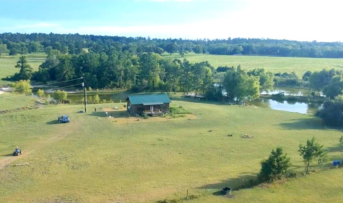 Aerial view of the log cabin and surroundings.