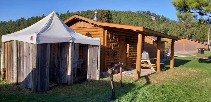 Camping log cabin and outdoor shower building