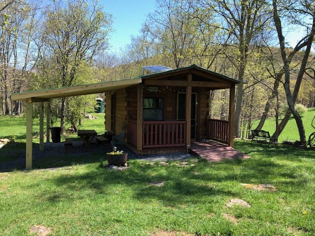The rustic cabin has a wooden patio roof as of 2019, which doubled the usable space at the cabin.