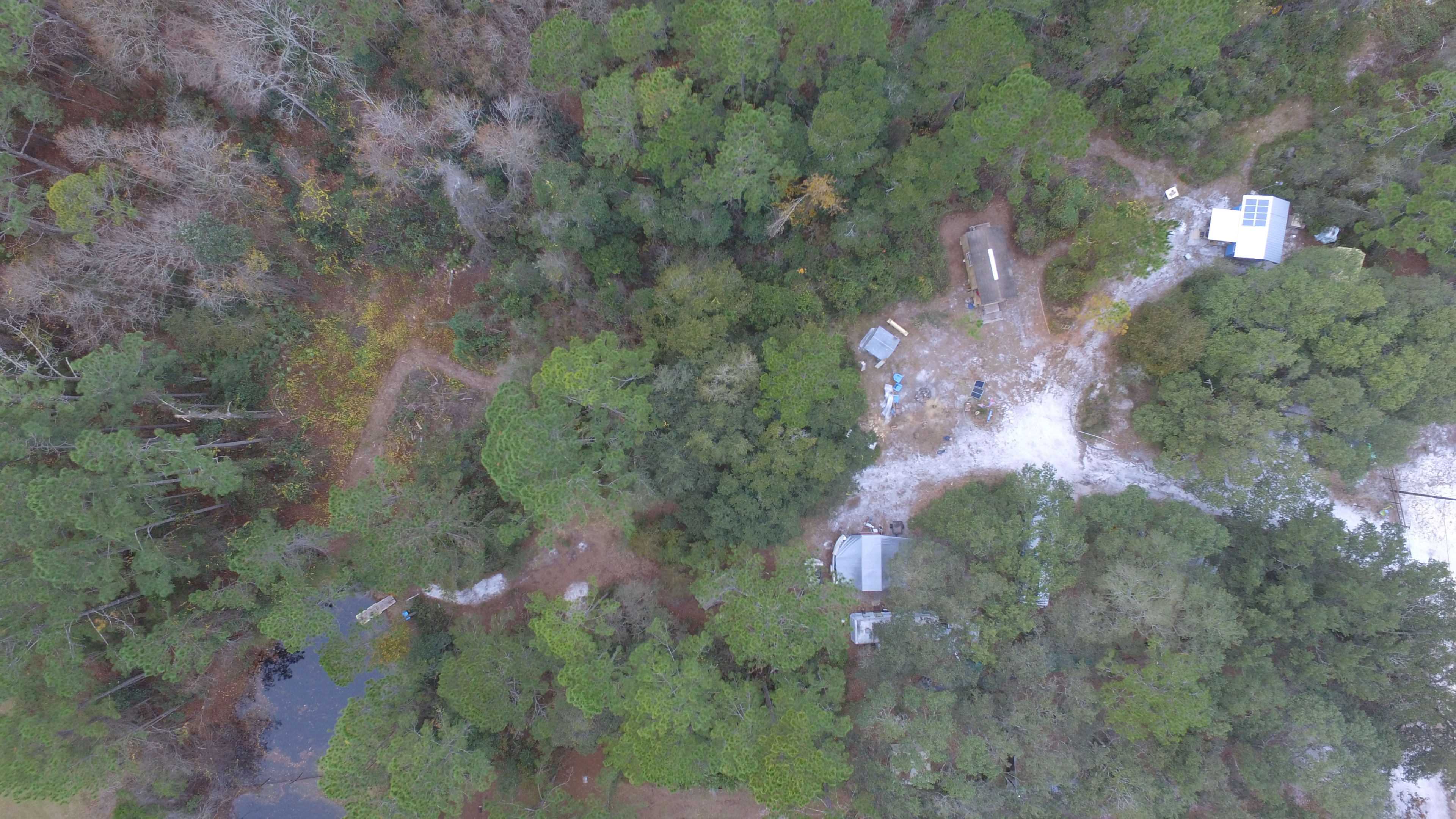 Aerial shot a guest took from his drone showing the original tiny house and pond.