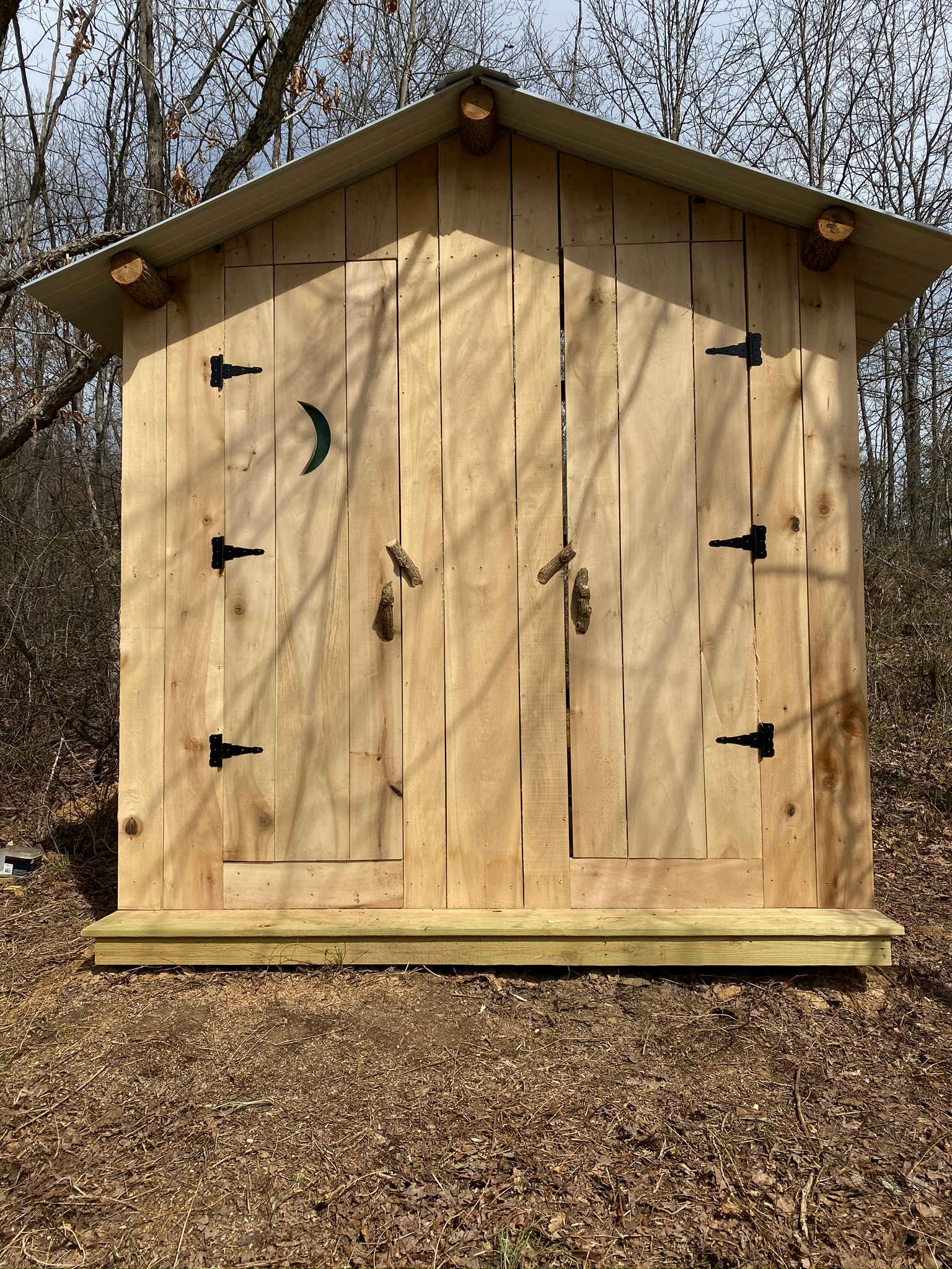 Here is our beautiful new outhouse (on the left) and changing room (on the right), by the pond.