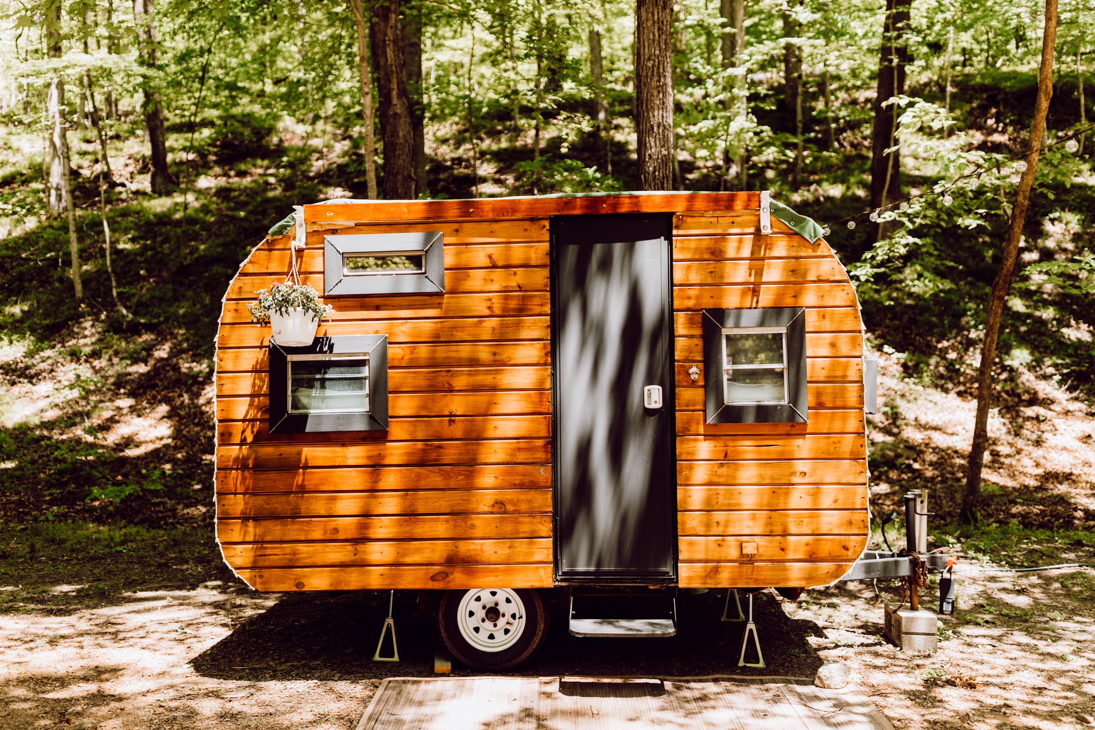 Vintage wood camper parked in beautiful Brown County, Indiana! This cozy camper was remodeled in 2020 with new flooring, paint, wall panels and much more! 