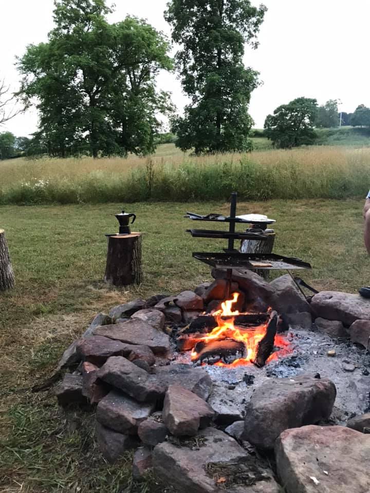 Fire pit with nice cooking apparatus that has 3 different tiers.   We used two for grilling and one as a table. It adds so much value to the camp site.