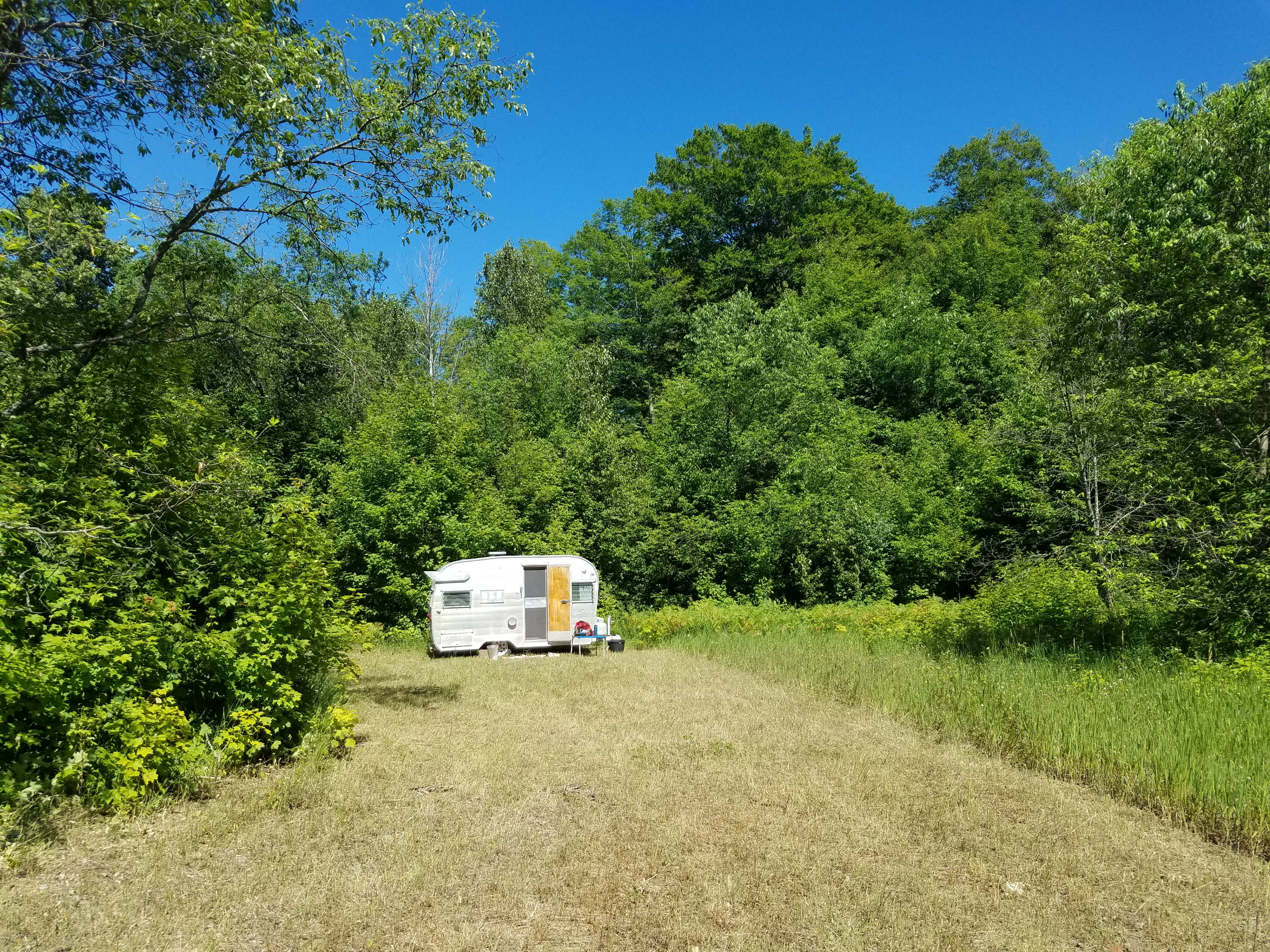 Our camping area. Feel free to peek in windows but the camper is locked so please don't try to enter. Inquire about rentals.