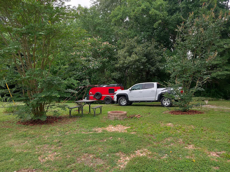 Our campsite was the only one in the open. It was to the left of the house. along the tree line. We had access to well water and were hooked up to 30 amp power. 