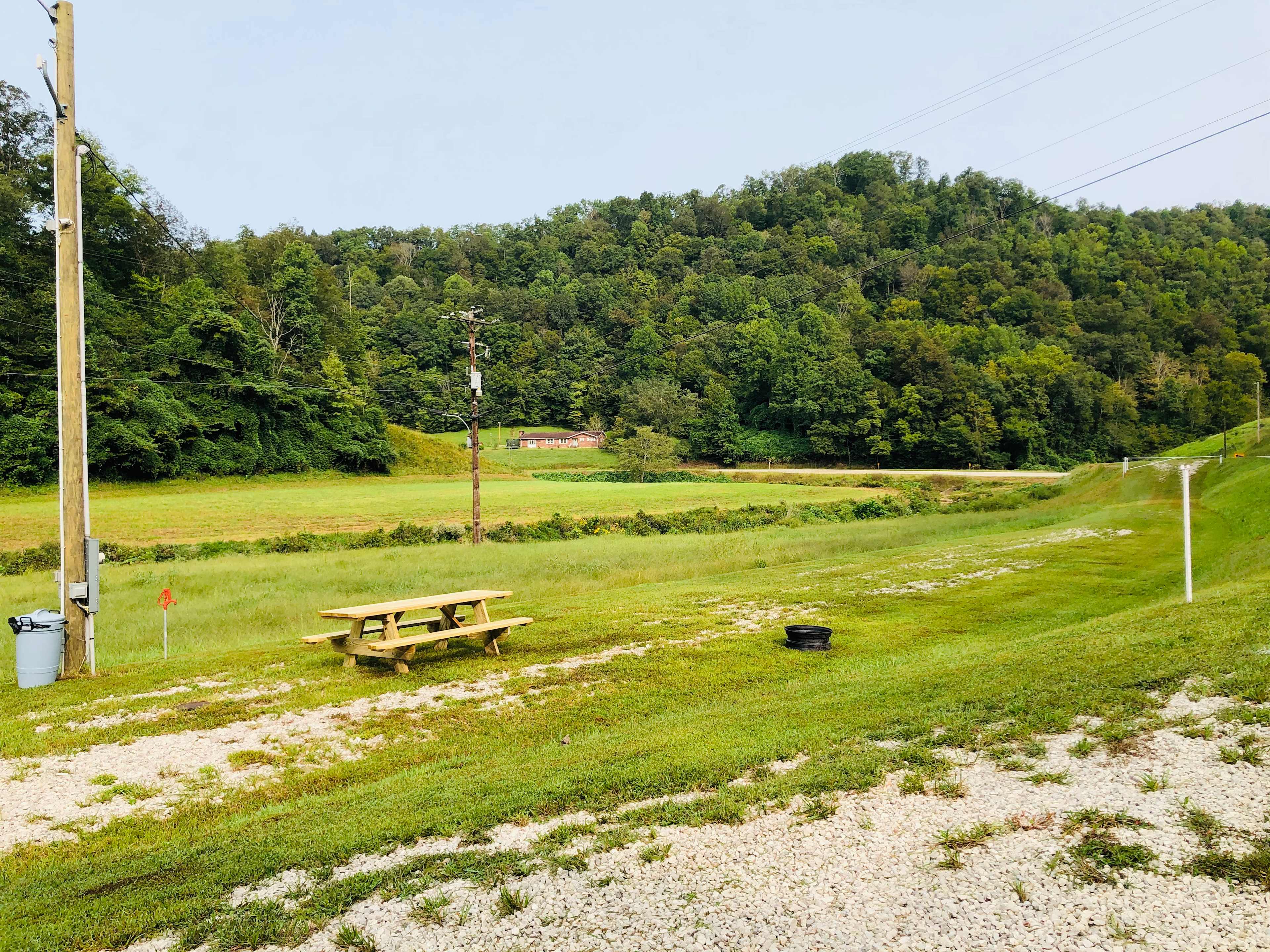 Double hookup site located next to a hay field and creek.