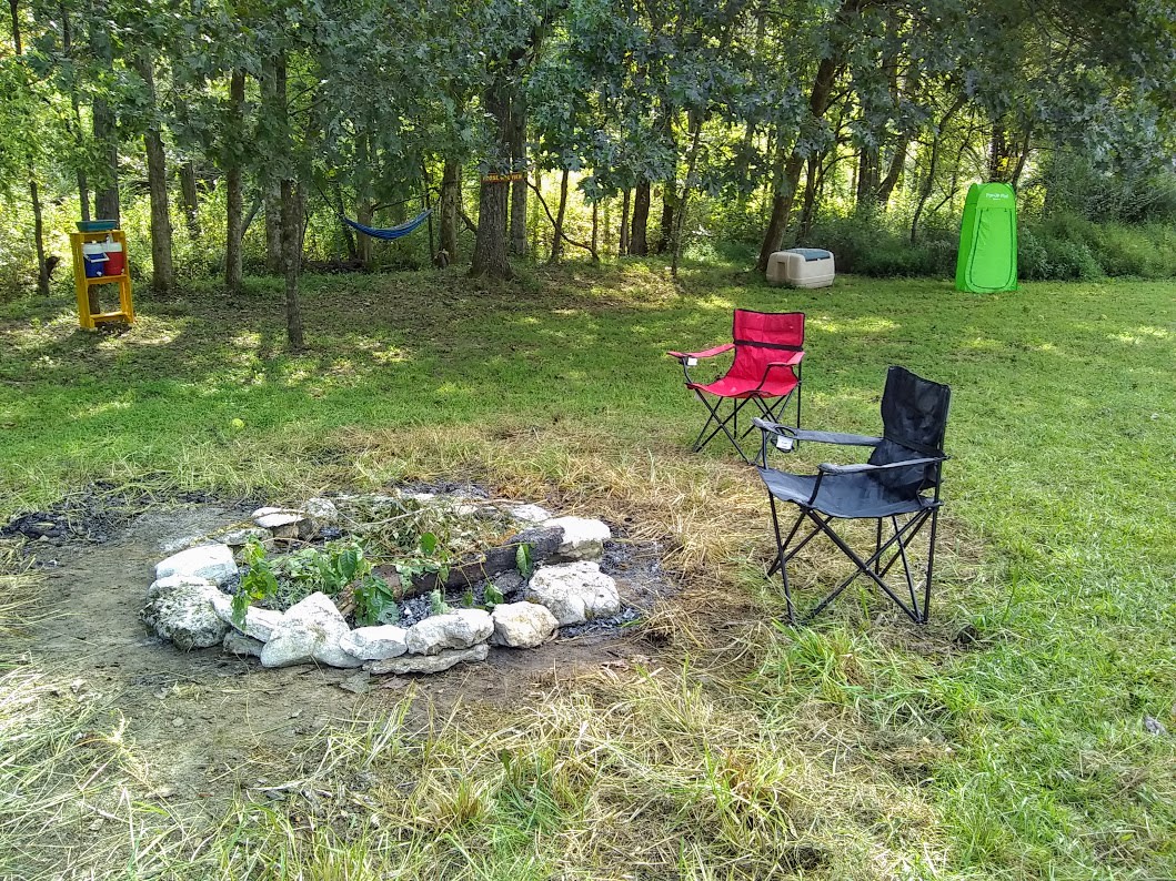 Nice big firepit. Green privacy tent in the background for toileting.