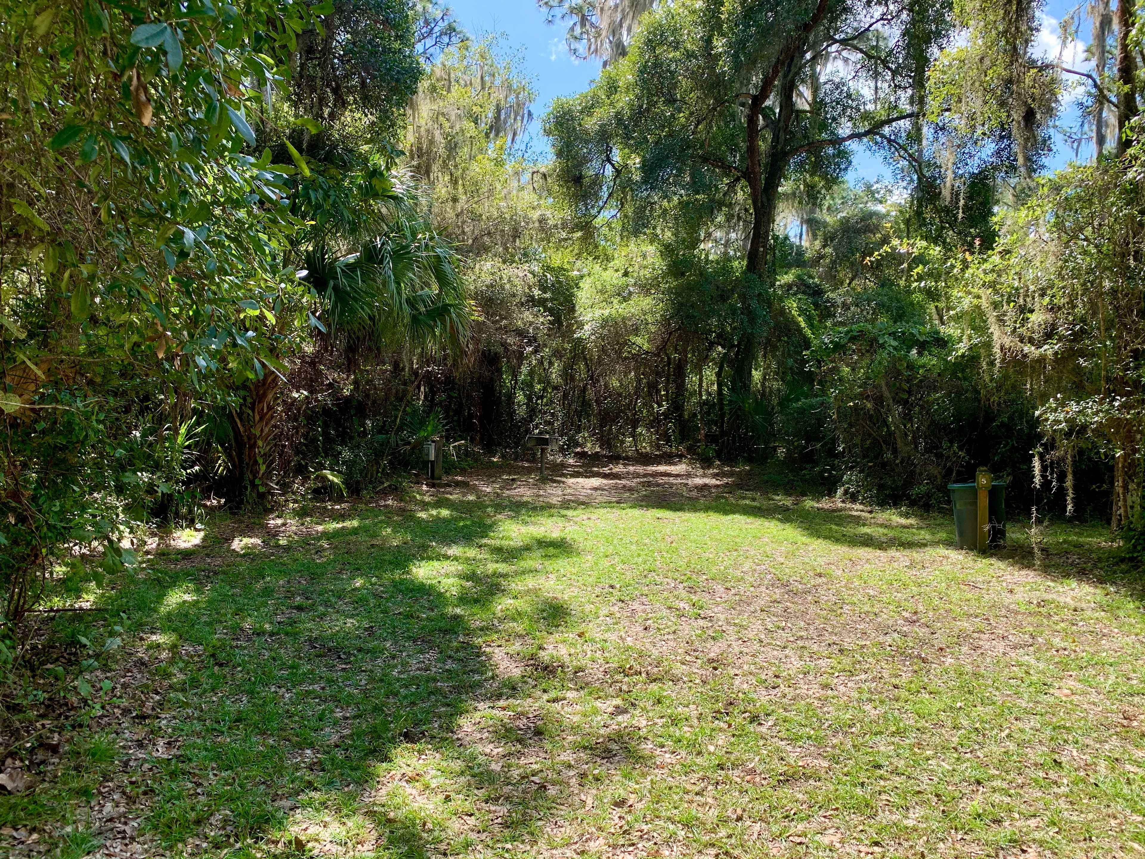 RV Site #5. Accommodates up to 30 ft. RV with water/electric/sewage hookups. Charcoal grill and picnic table.