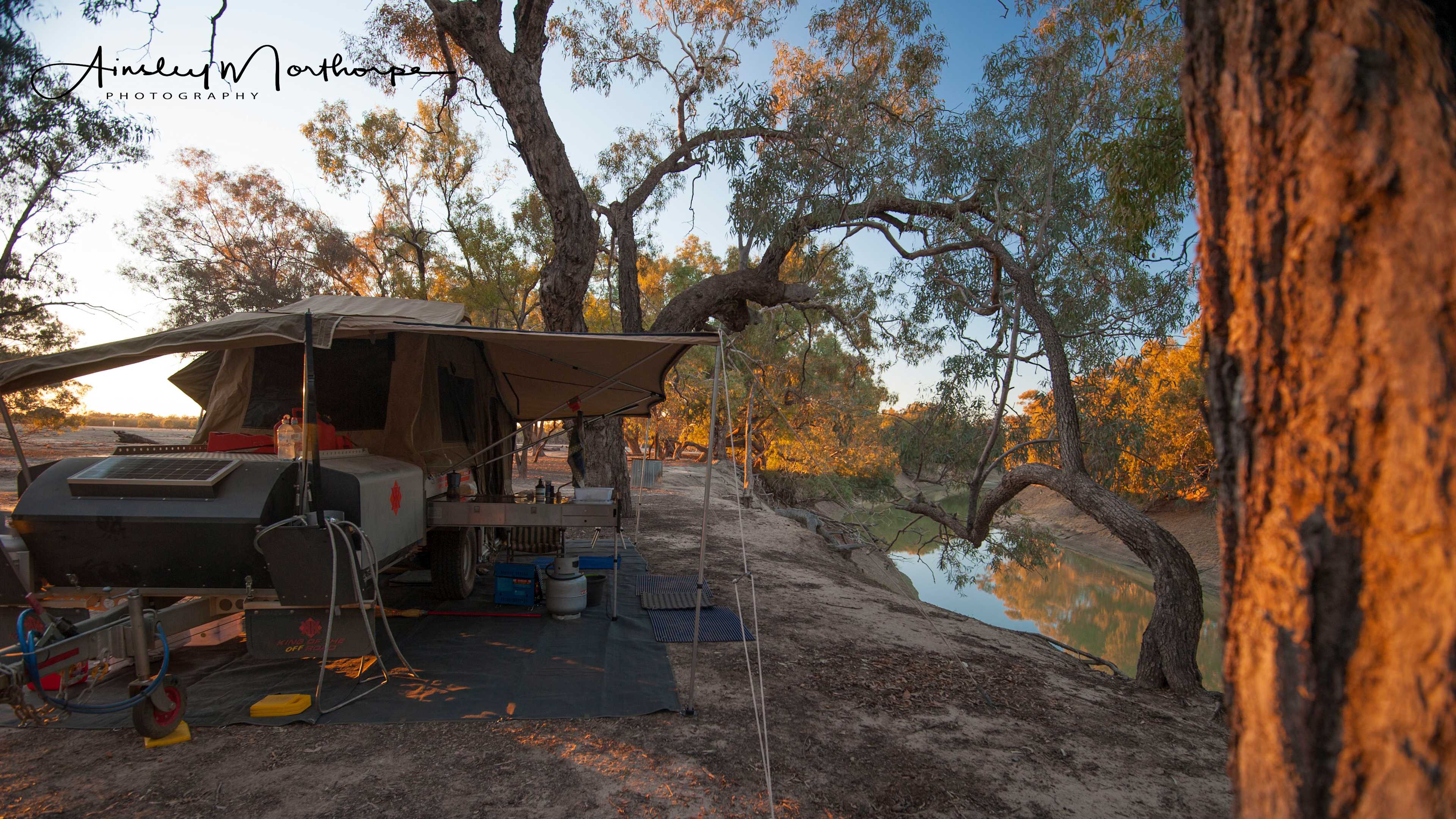 River campsite with firepit, wood to get you started, rubbish and recycle bins and a long drop loo nearby. It's a drive to bathroom/laundry facilities.