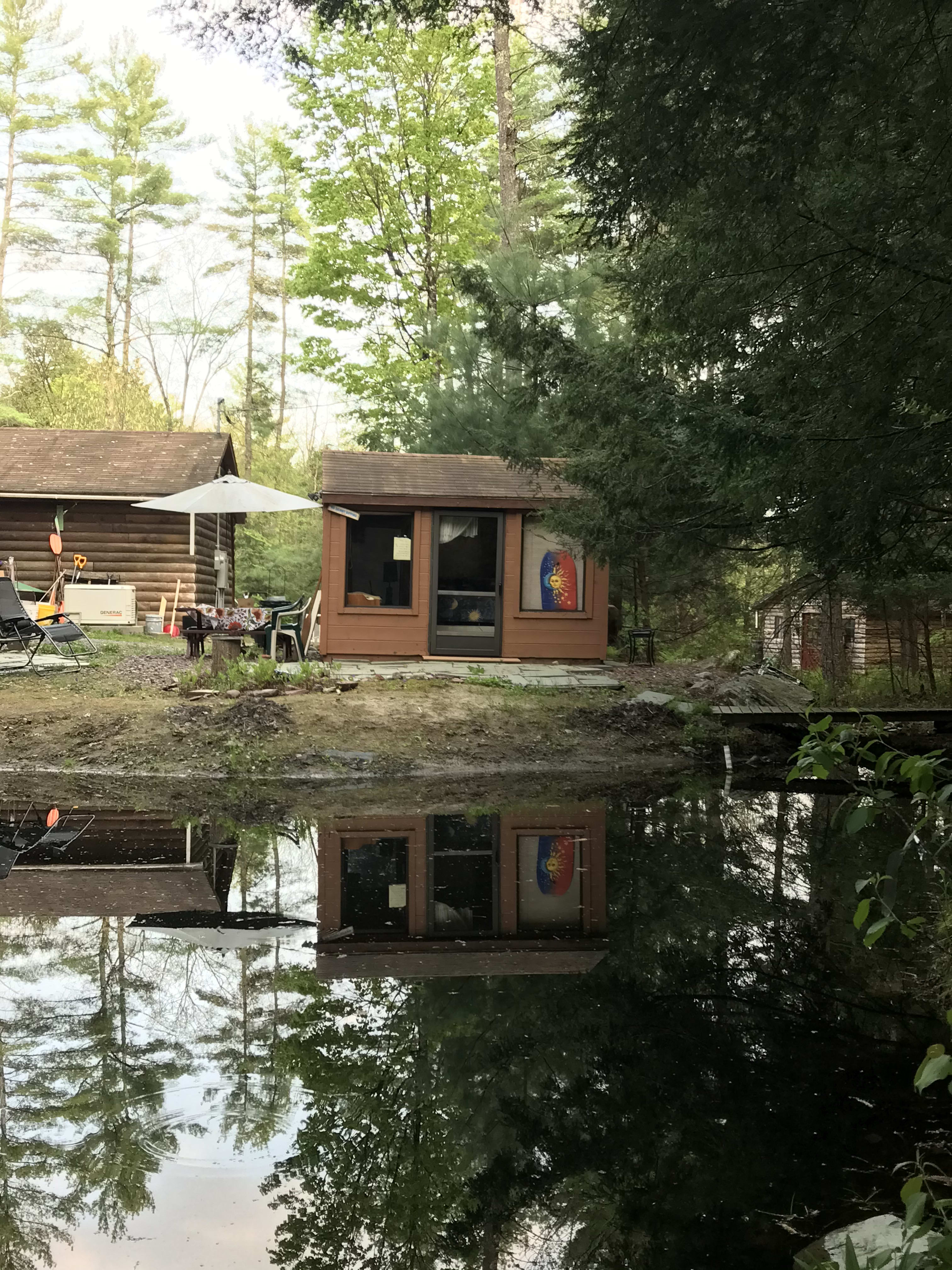 Screen house on the pond , garage and Grotto cabin in background. 