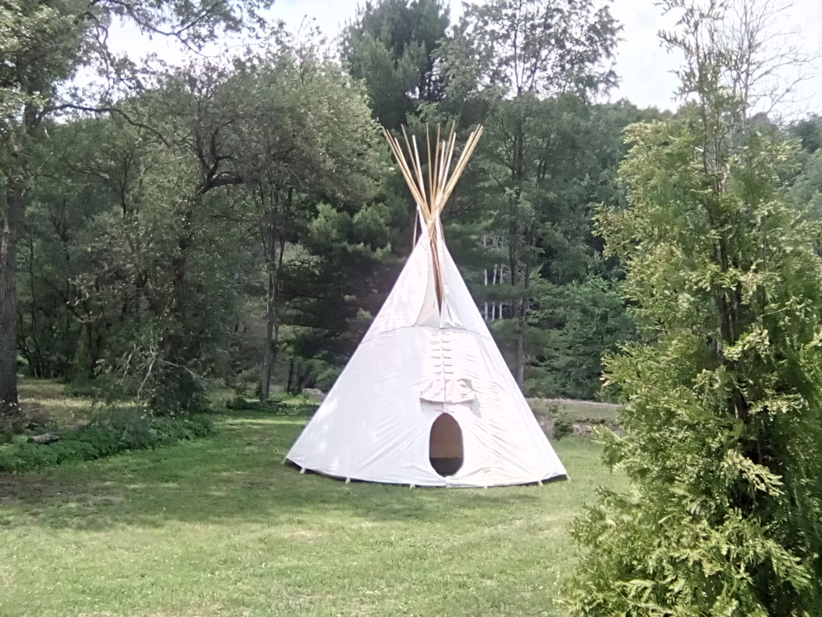tipi by the stream