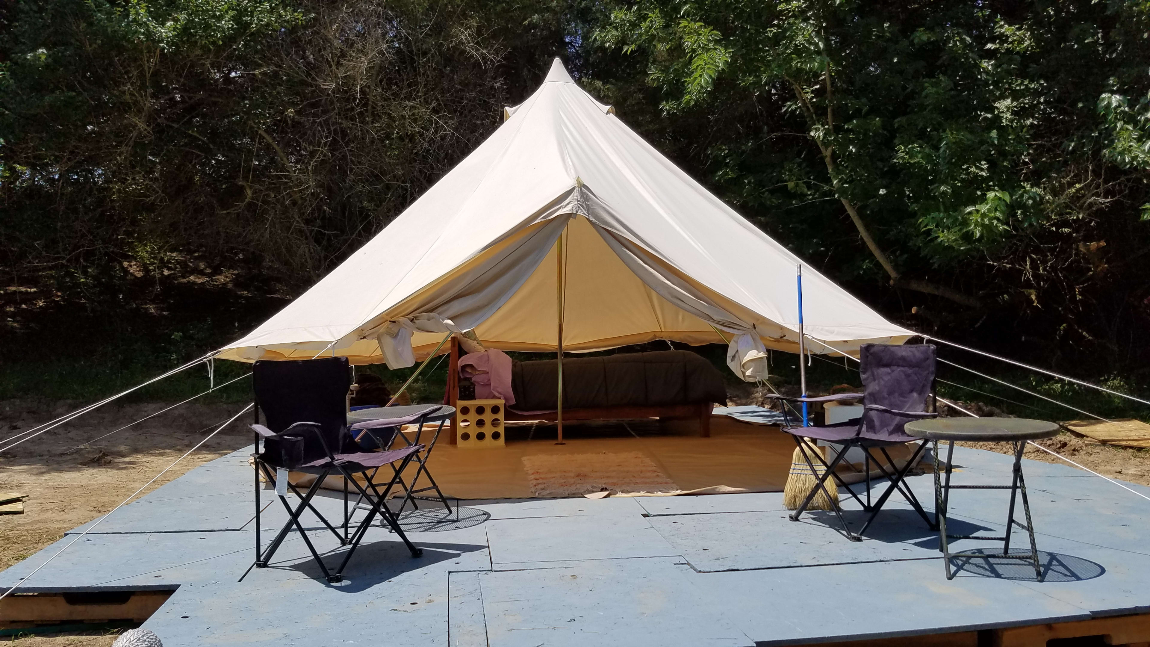16 Foot bell tent with a queen size blow up mattress on a bed frame with complete linens available for your use or set up your own tent. 