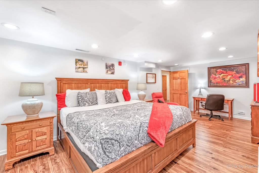 The Red Room.  King sized Bed with Red Mini-Fridge, red recliner, Television, alarm clock, mini-fan, dresser, closet and work desk.  Oak furniture and a spacious room.  Cheerful bright wall hangings and a restroom just across the hallway.  