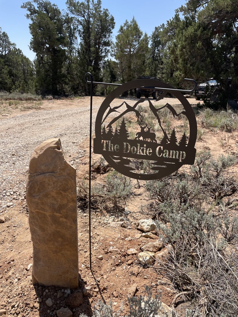 Sign located on left side of the road at the campsite entrance.