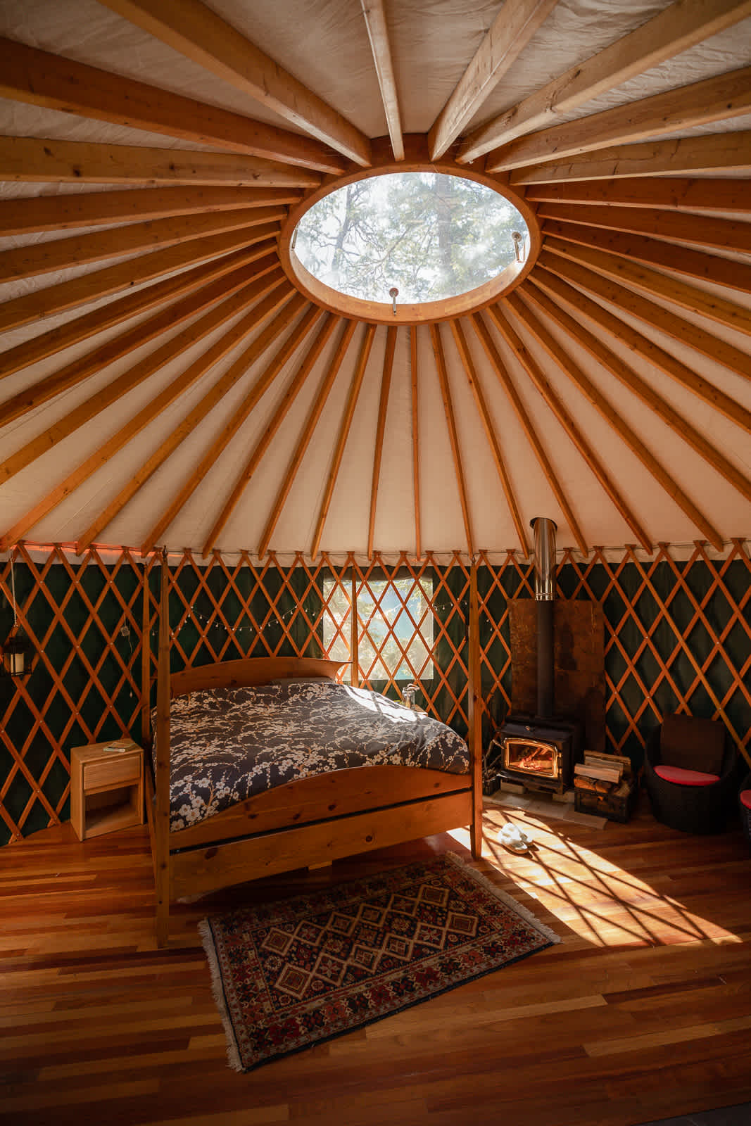 Interior of one of our Yurt's - gaze at the stars through the skylight from your bed at night or daydream through the trees during the day.