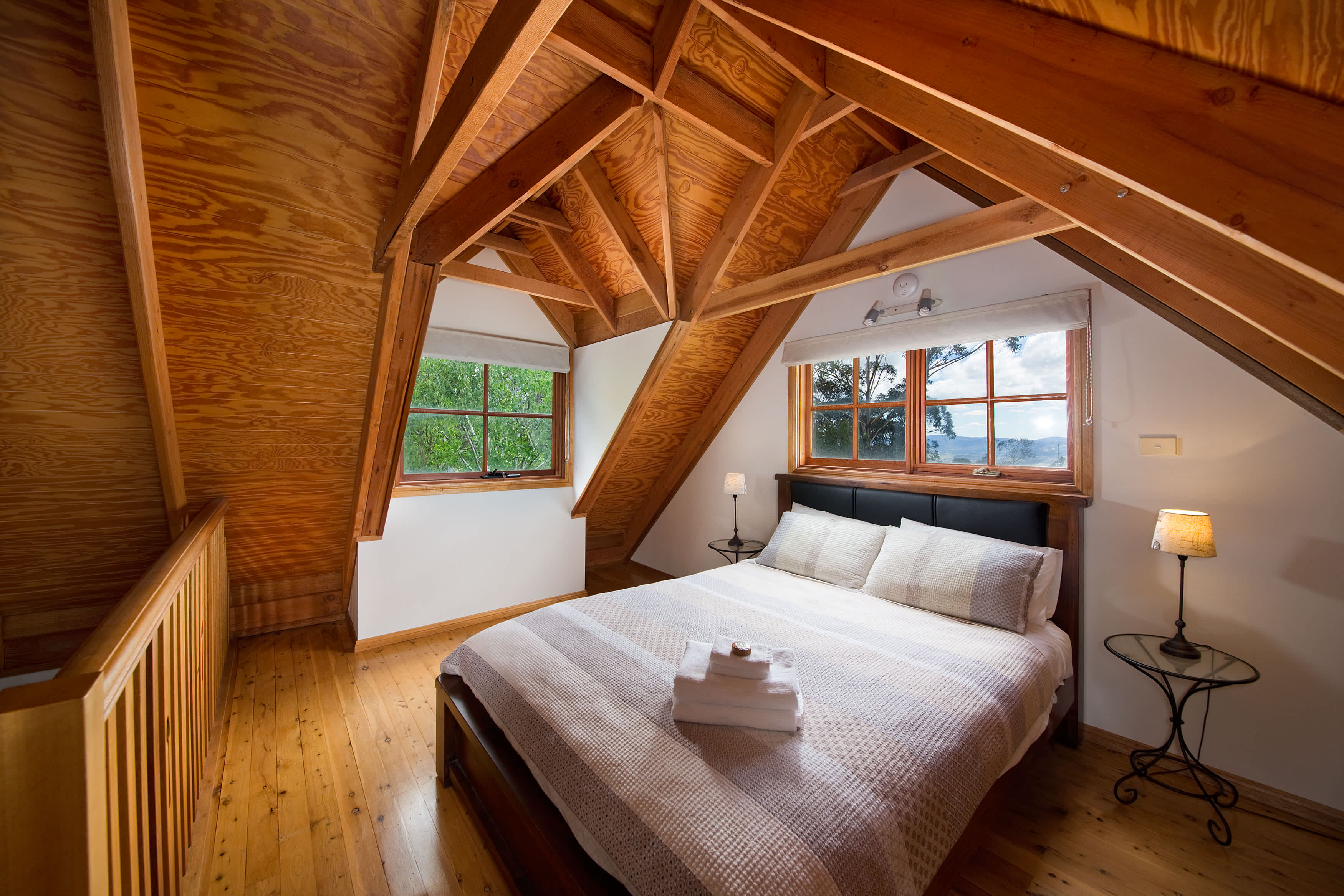 The loft bedroom with distant views of the Kanimbla valley. Classic Blue Mountains cottage style. Premium A.H.Beard Kingcoil queen mattress.