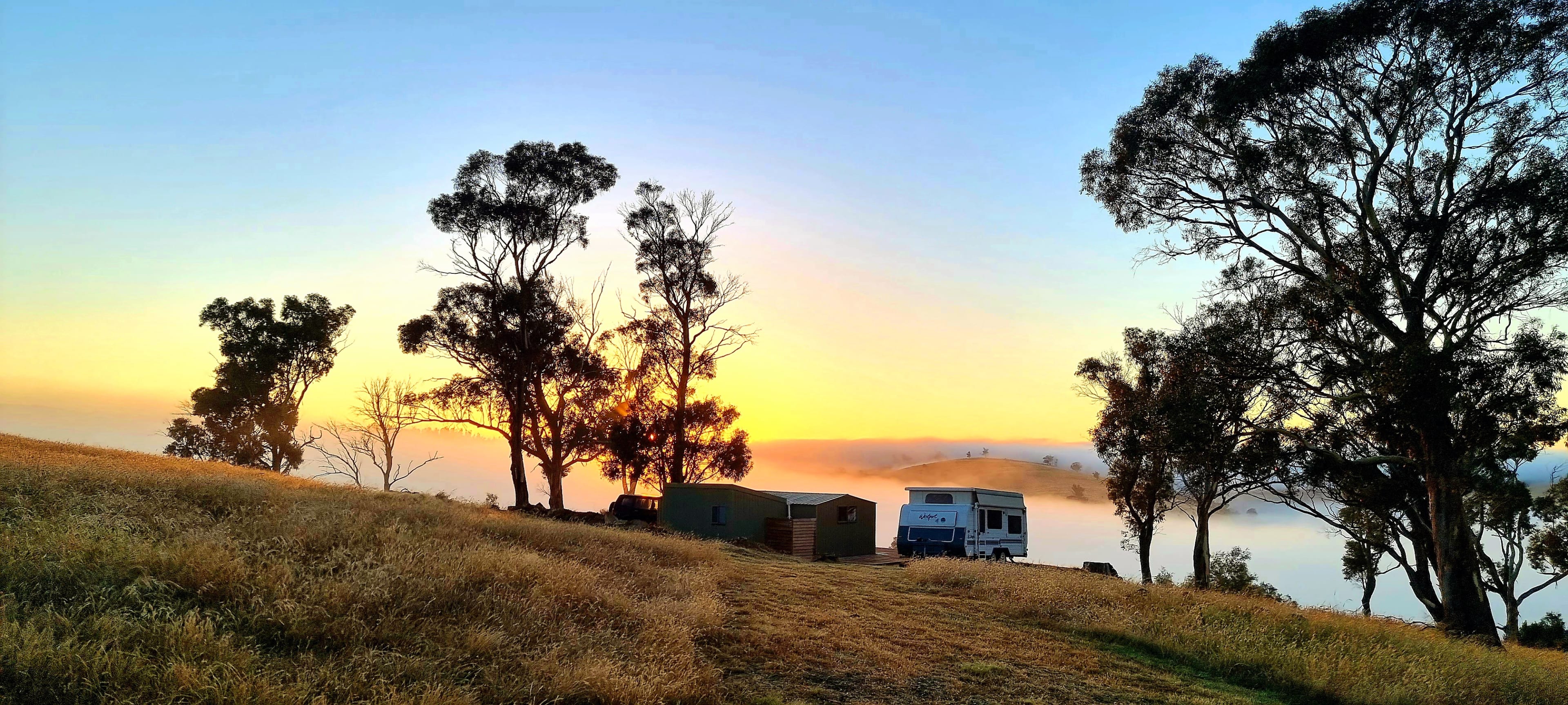 Cabin and van at sunrise