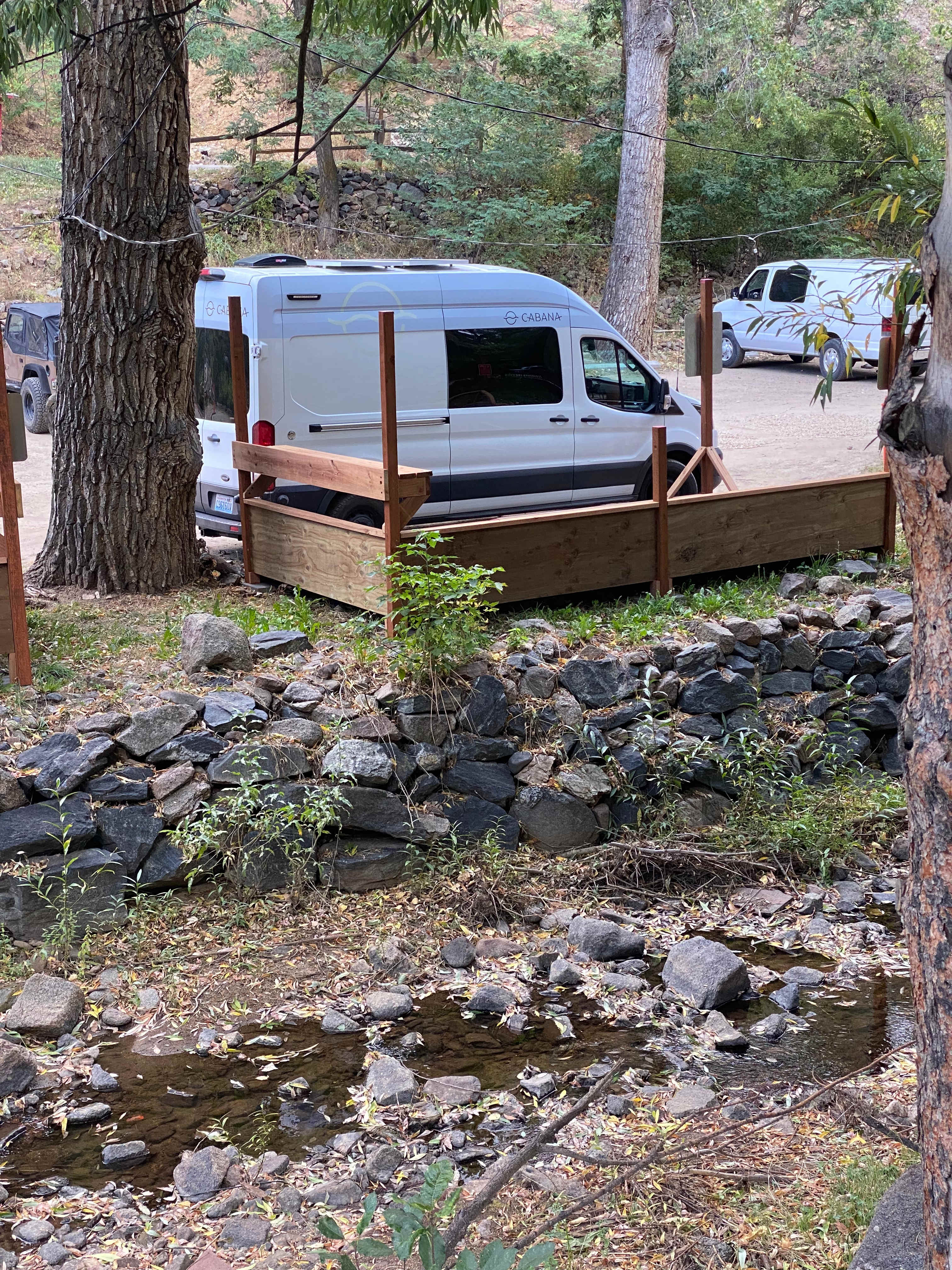 Vanlife campsite with creekside deck