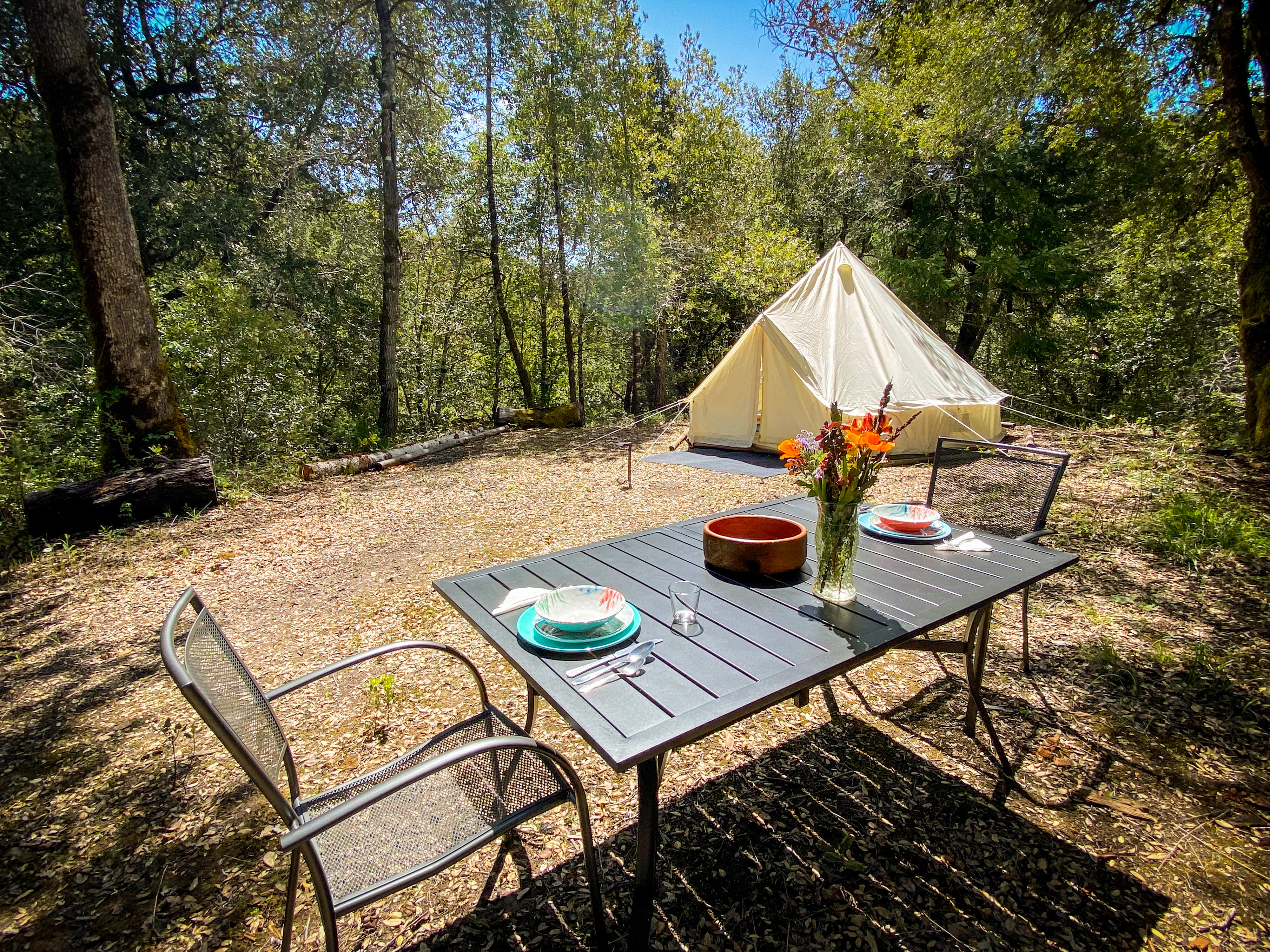 The Knoll campsite has a 13ft diameter round tent, privacy fencing, an outdoor kitchenette with a 1-burner propane stove, and complete dining table. There is an outdoor shower, as well as garbage and portopotty service. 