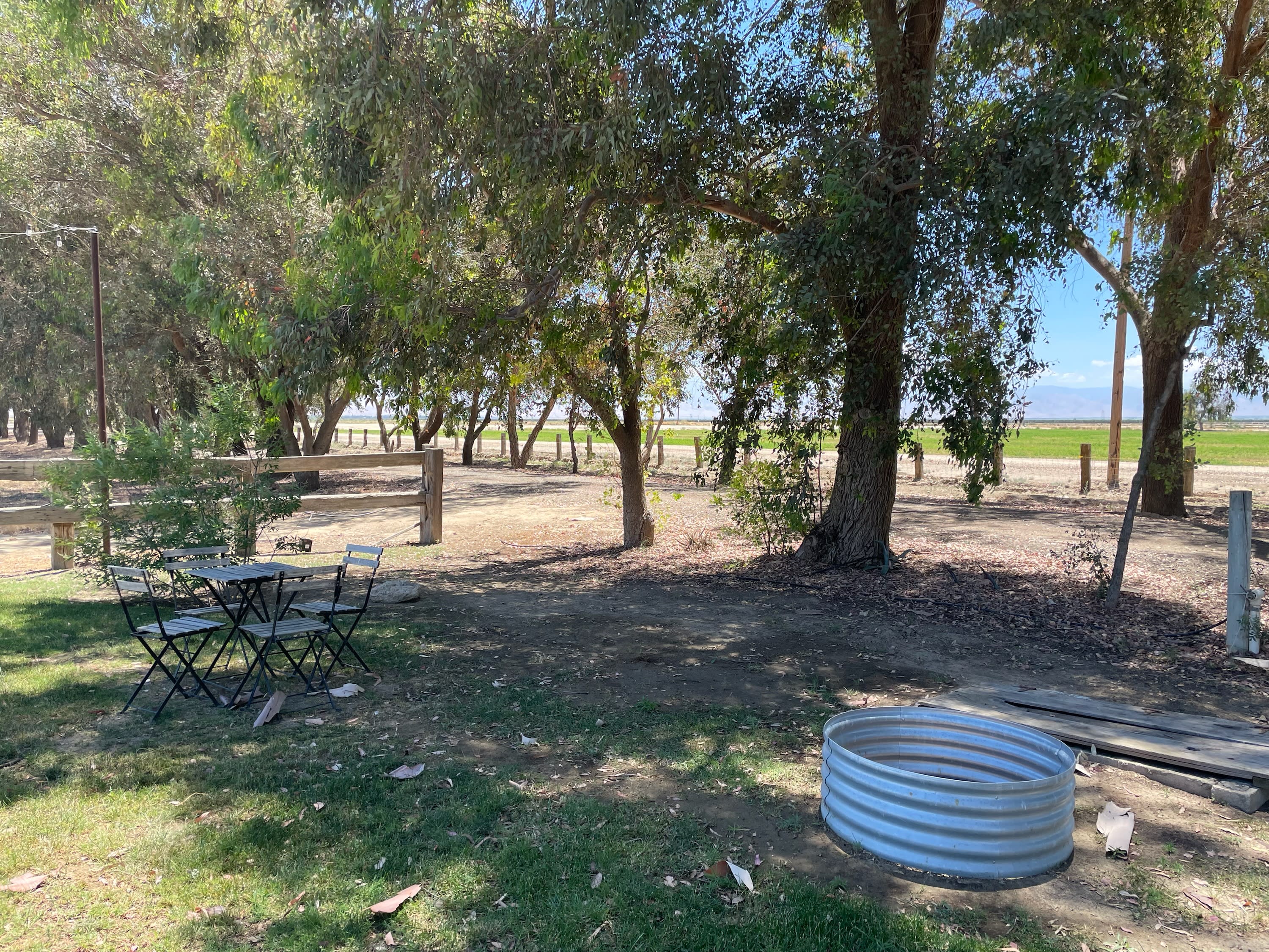 BYO Tent Site is shaded and includes bistro table & chairs, fire pit and water spigot