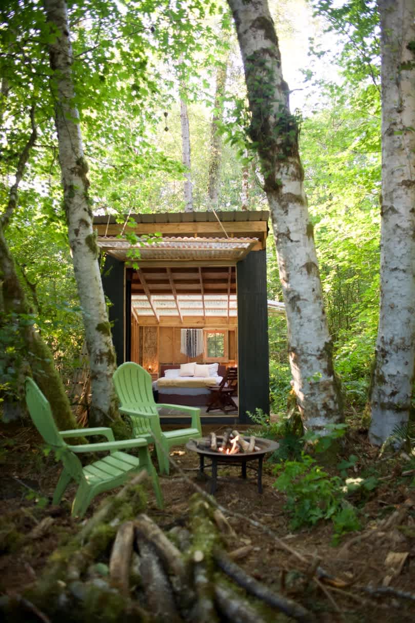 Garage door open. Cabin space opens to the forest. 
Insect screen protects indoor space from bugs.