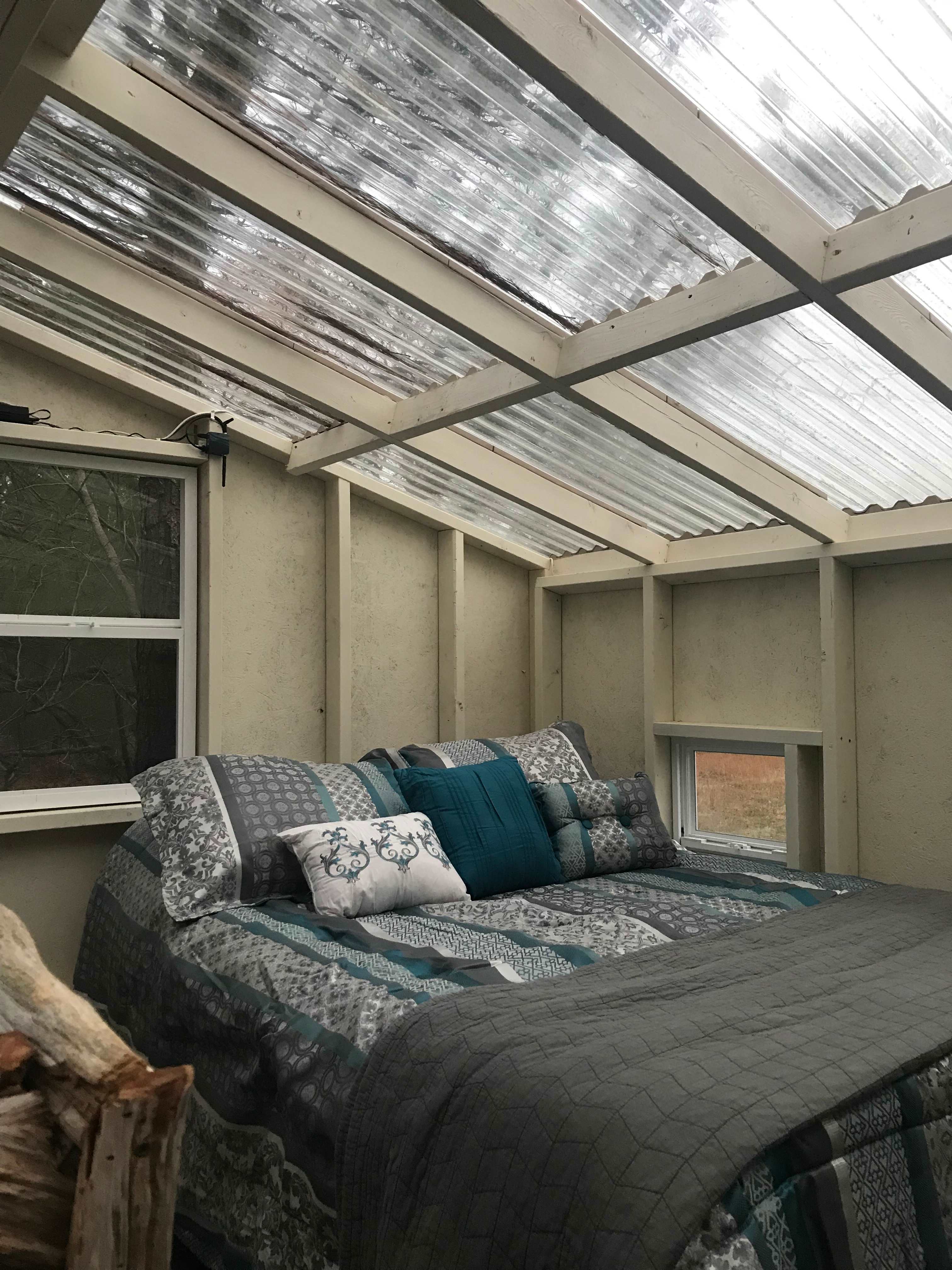 Upstairs with clear roof so you can see the sky and trees