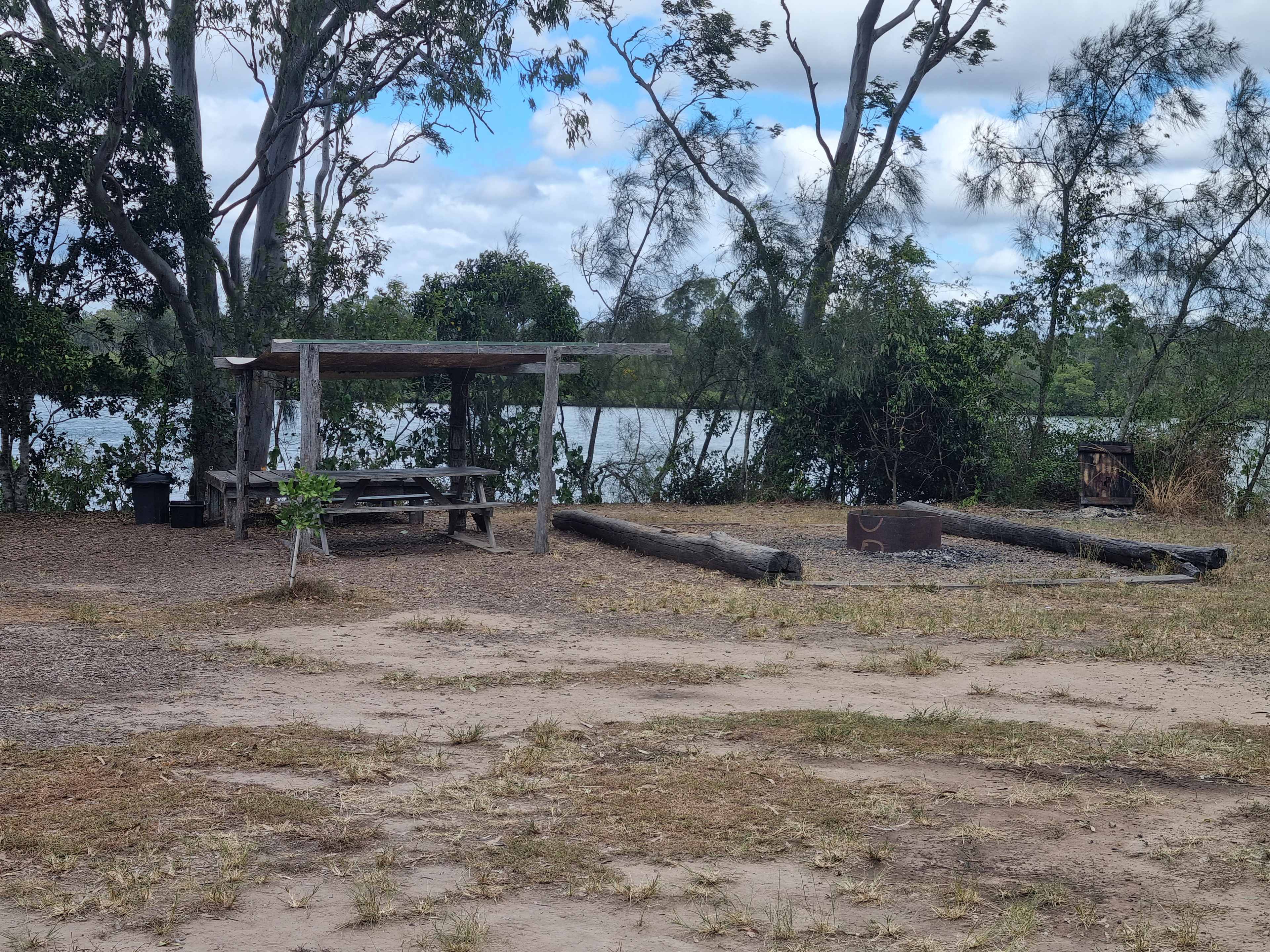 Covered table and seating with large fire pit right on the river front