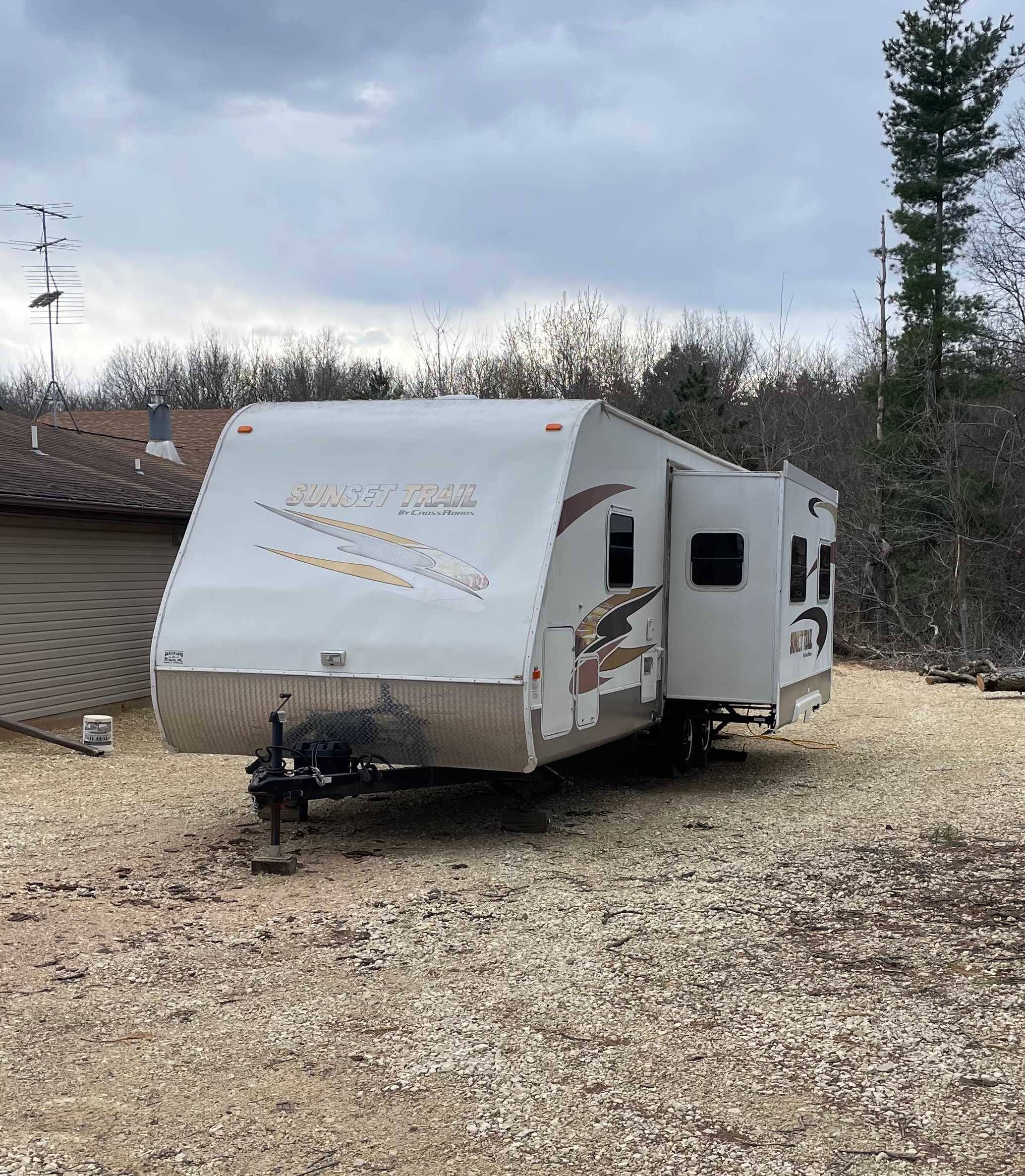 Sunset Camper with slide out open, parked next to the Manor House. This unit is not parked on the campsite in this picture.