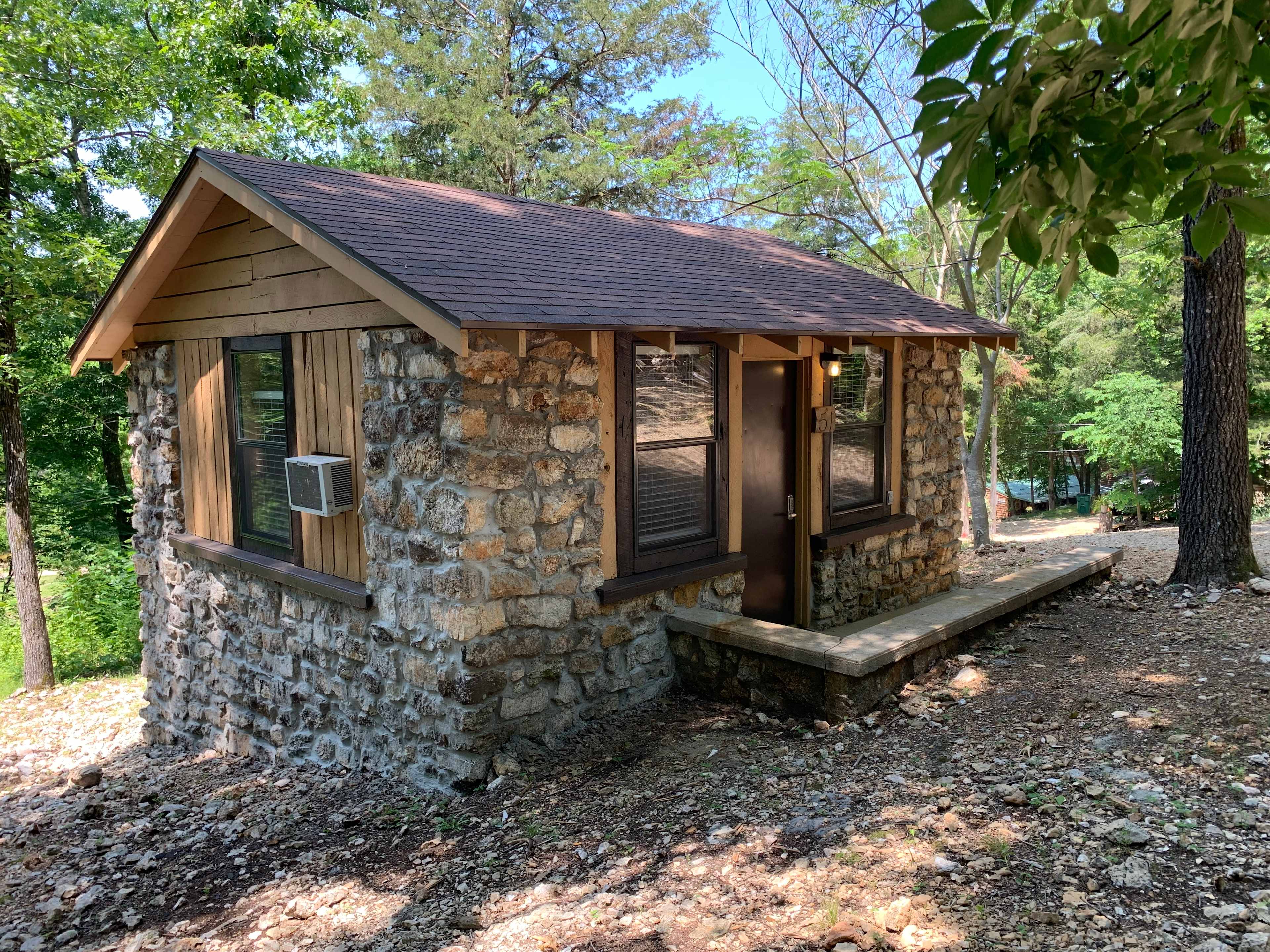 This is Cabin 51. Cabin 51 has a queen sized bed and uses 1/2 of the separate bathhouse which has a toilet, shower and sink for your private use. The bathhouse is a short walk from the cabin.