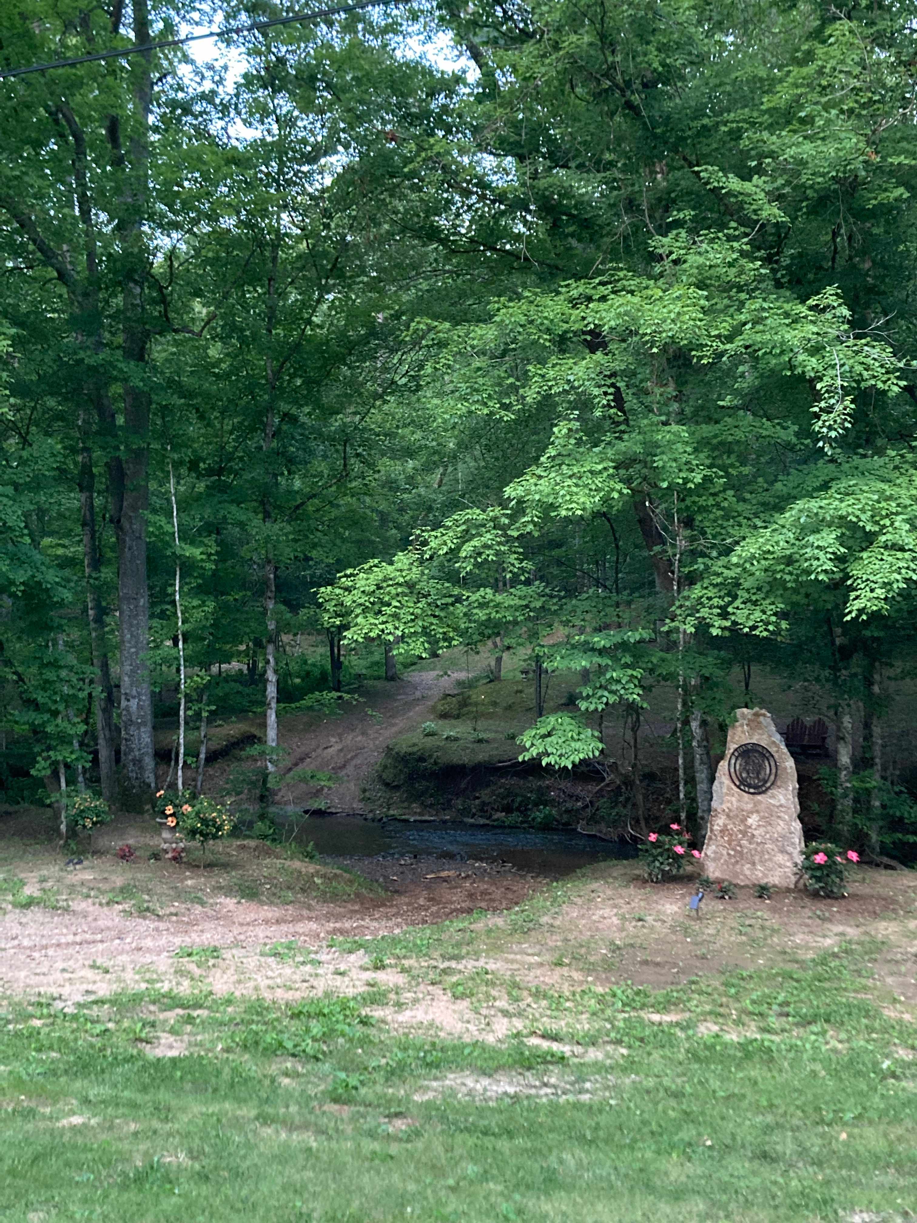 The entrance goes right through the creek.   Site 1 is on the left of the drive and Site 2 to the right.


