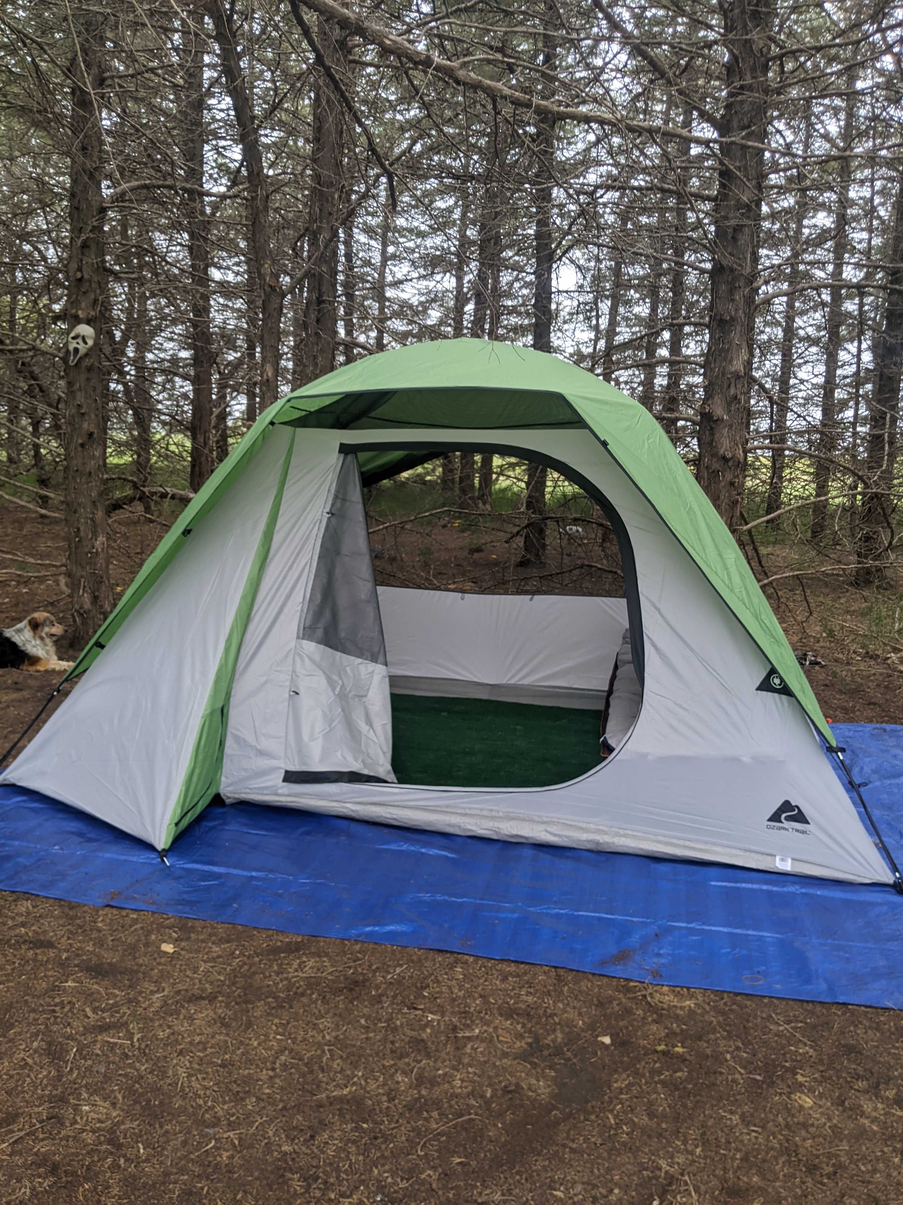 Included are 2 cots, end table, lamp, 2 bag chairs, picnic table, fire pit, and use of the outdoor kitchen and modern bathrooms
