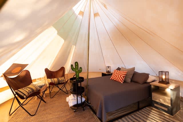 Tent inside with Queen bed, mini fridge and AC