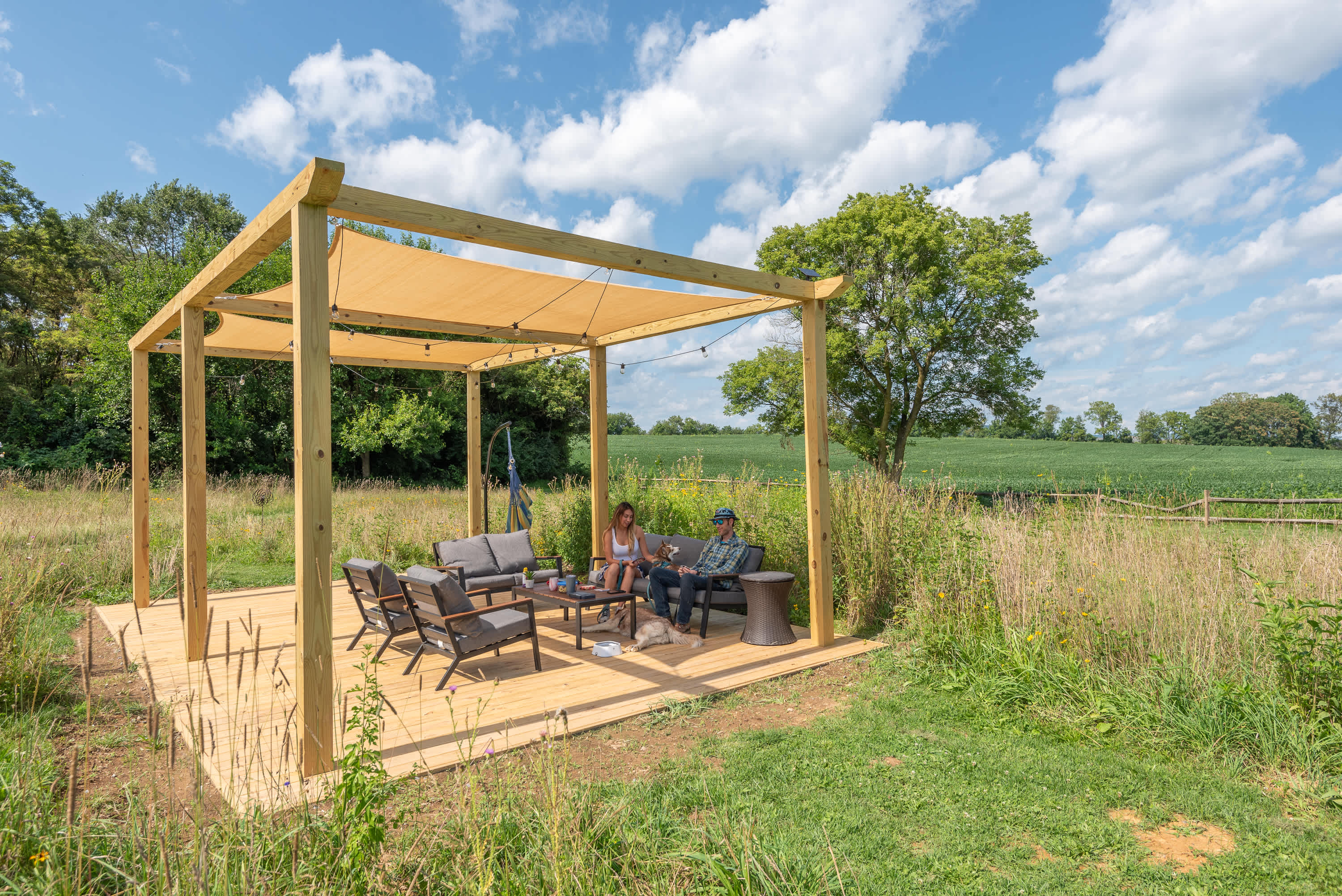 The pergola is furnished with some chairs and tables. It's a great spot day or night to relax, read, drink, play card games, or just enjoy being surrounded by nature.