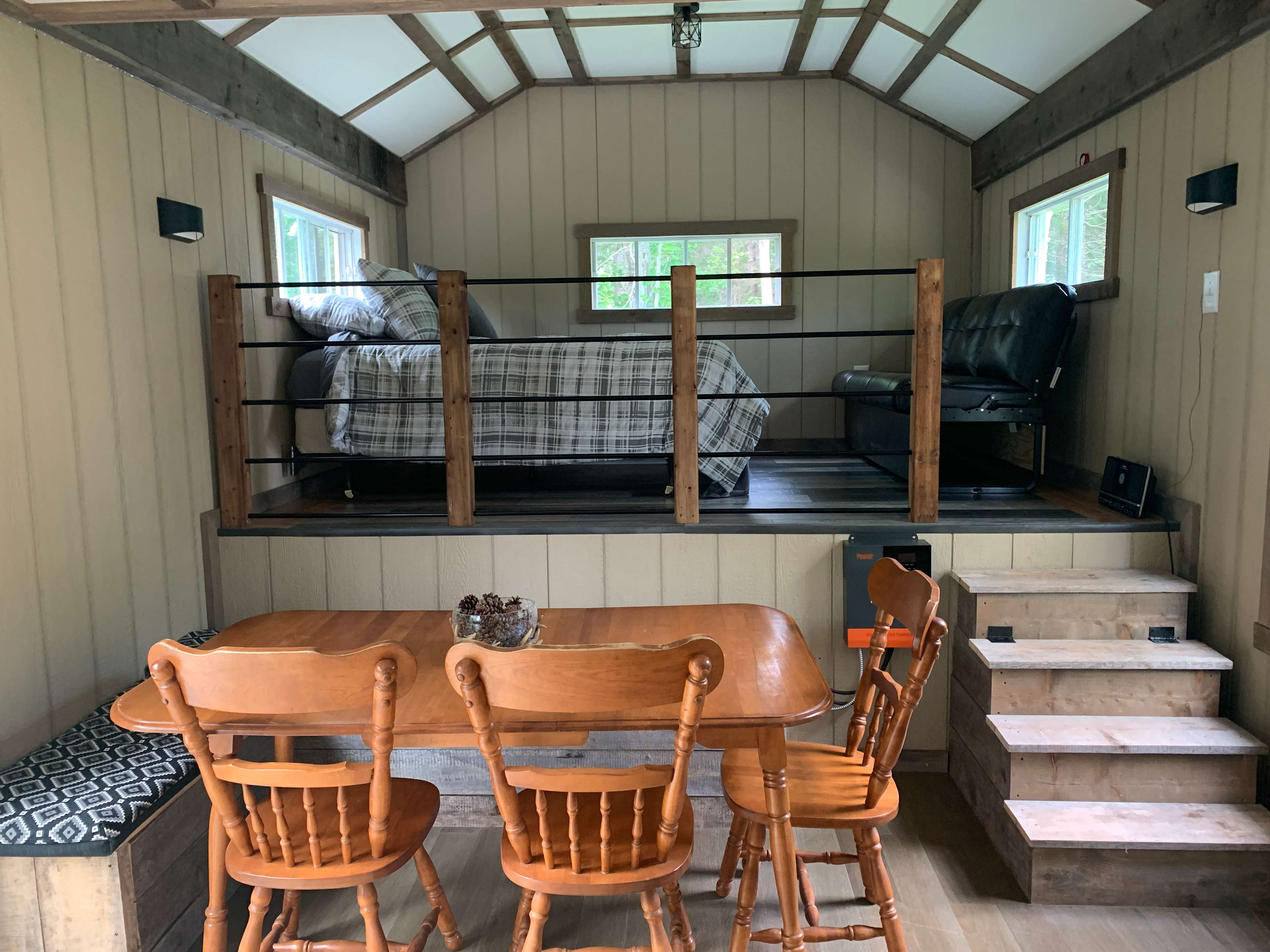 Kitchen table with bench storage seating & upper loft area for sleeping and relaxing.