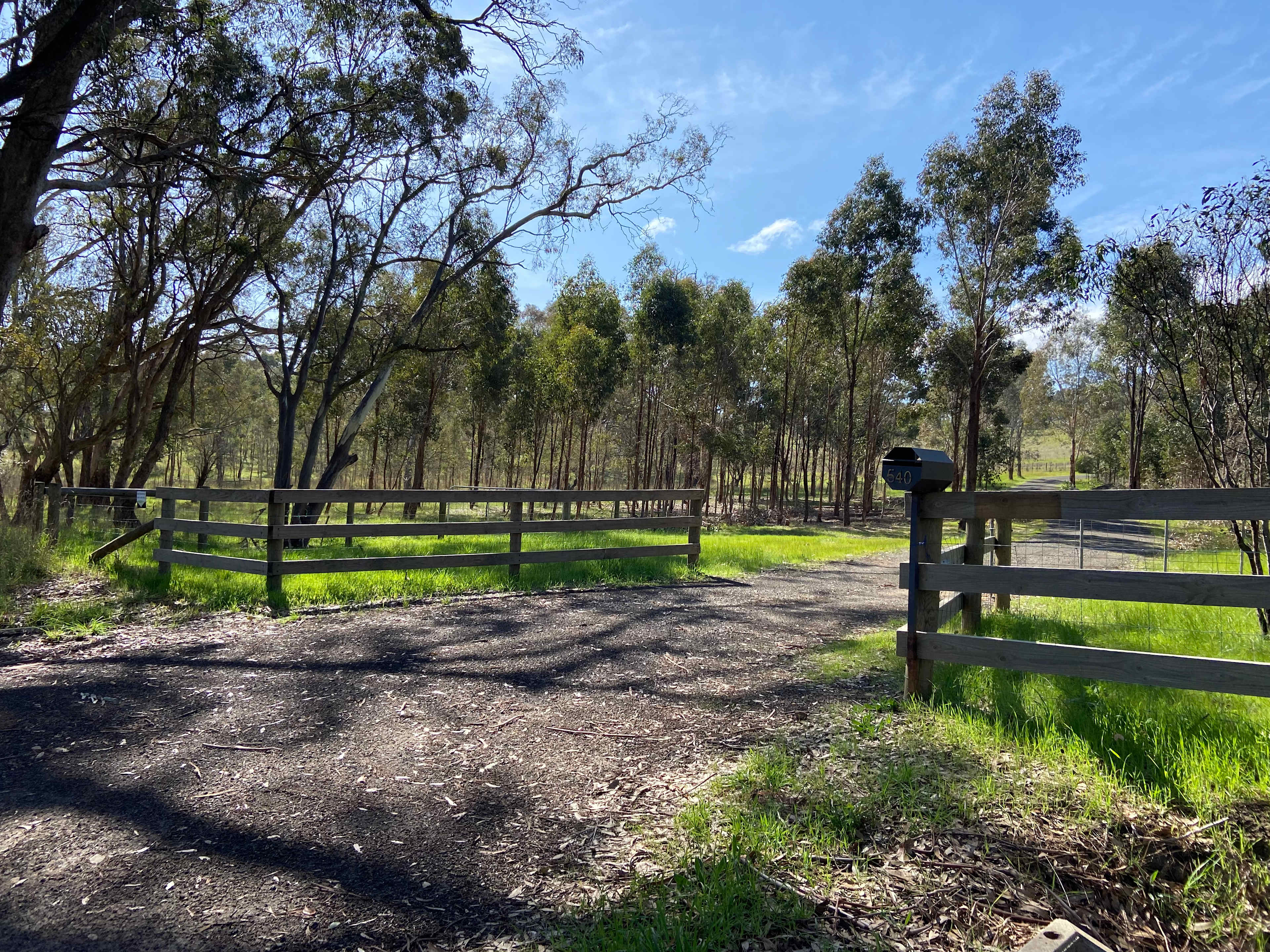 Driveway entrance. Camping through gates in paddock on left.