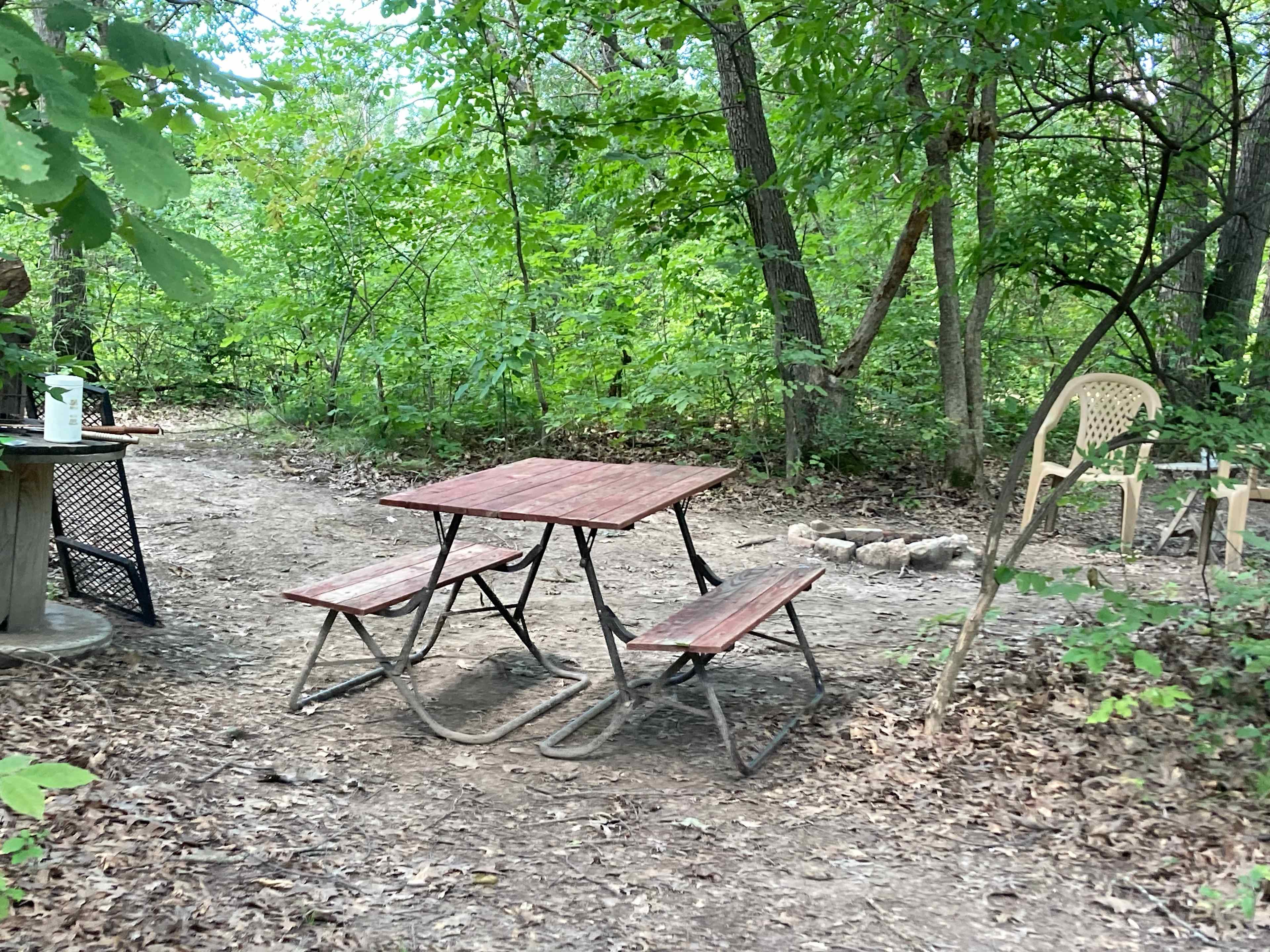 Fully stocked with comfortable chairs ,4 person picnic table, fire pit and grill top, side table, fire starters, and level site. 
