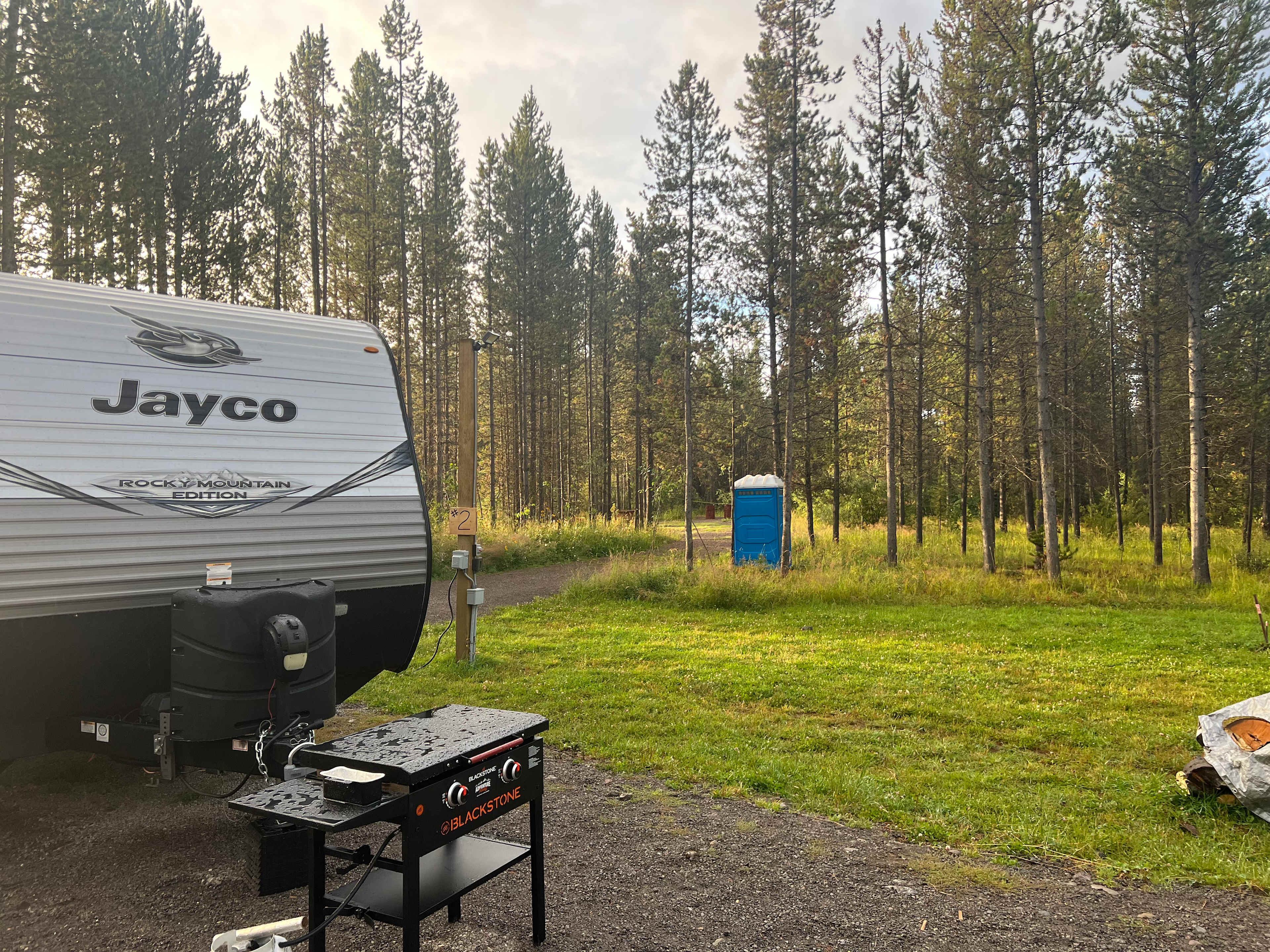 View to the back of the lot, very wooded, side by side and dirtbike trails right behind it so bring your toys