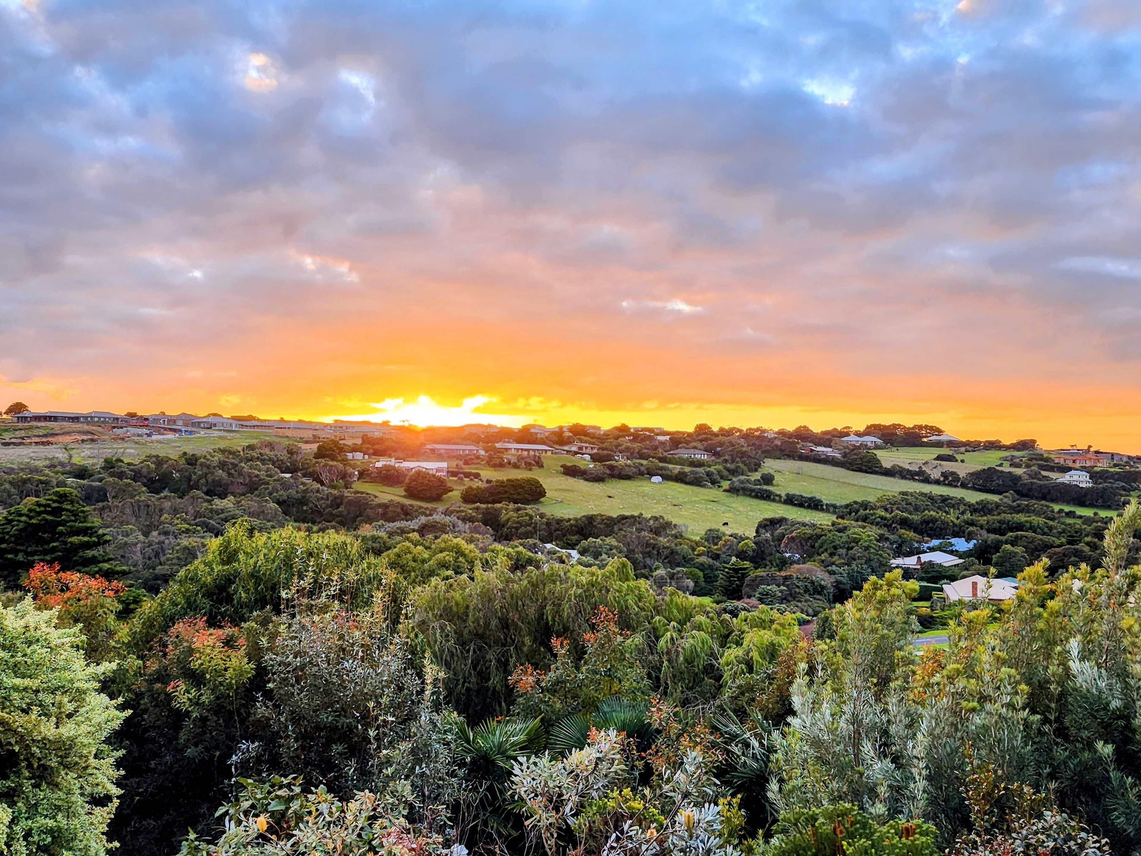 Sunrise is often very special. This view is looking out across the garden and Logans Beach Valley from seat above the the Sea Mist sign.