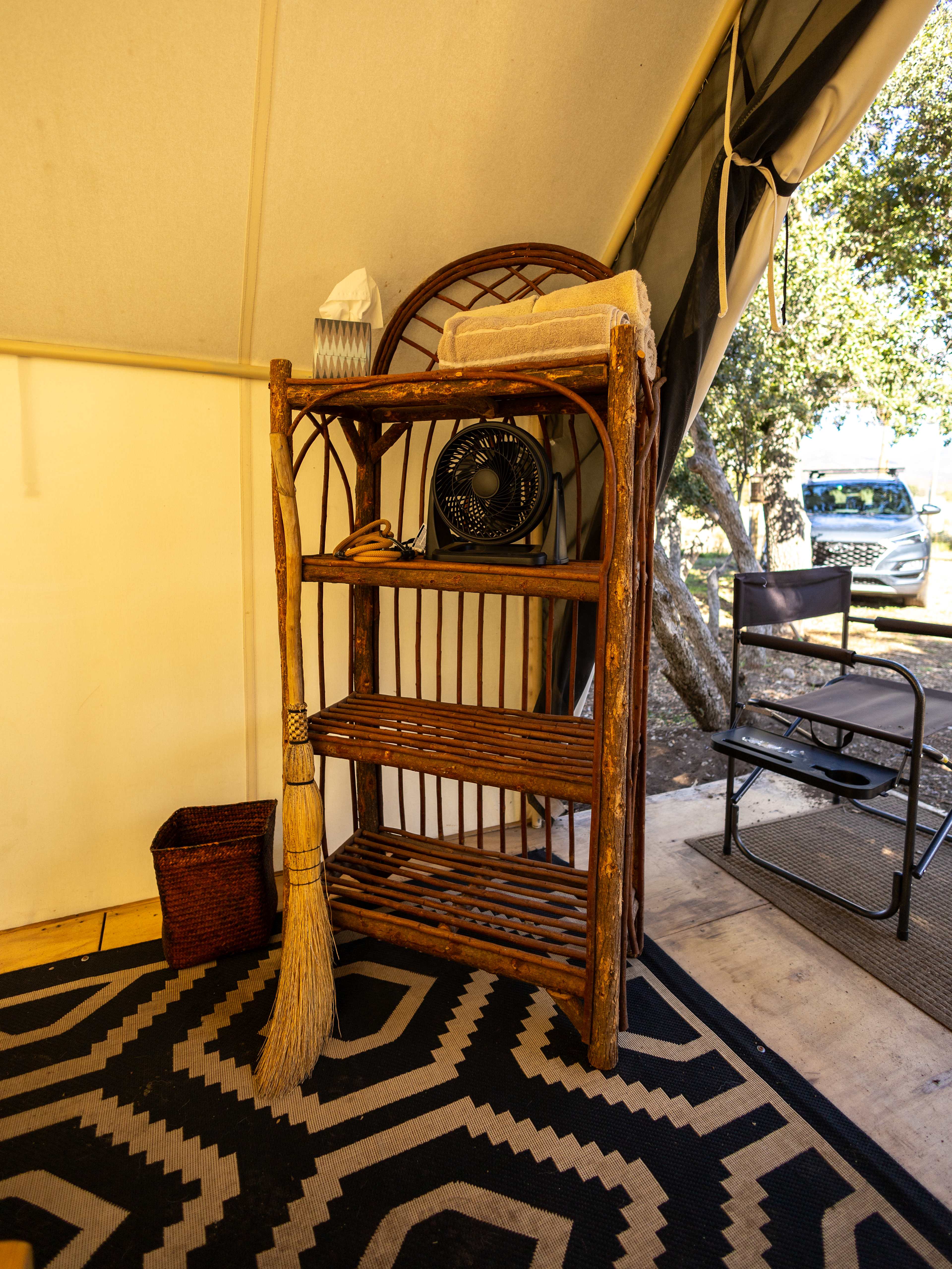 Shelf and broom in the glamping tent