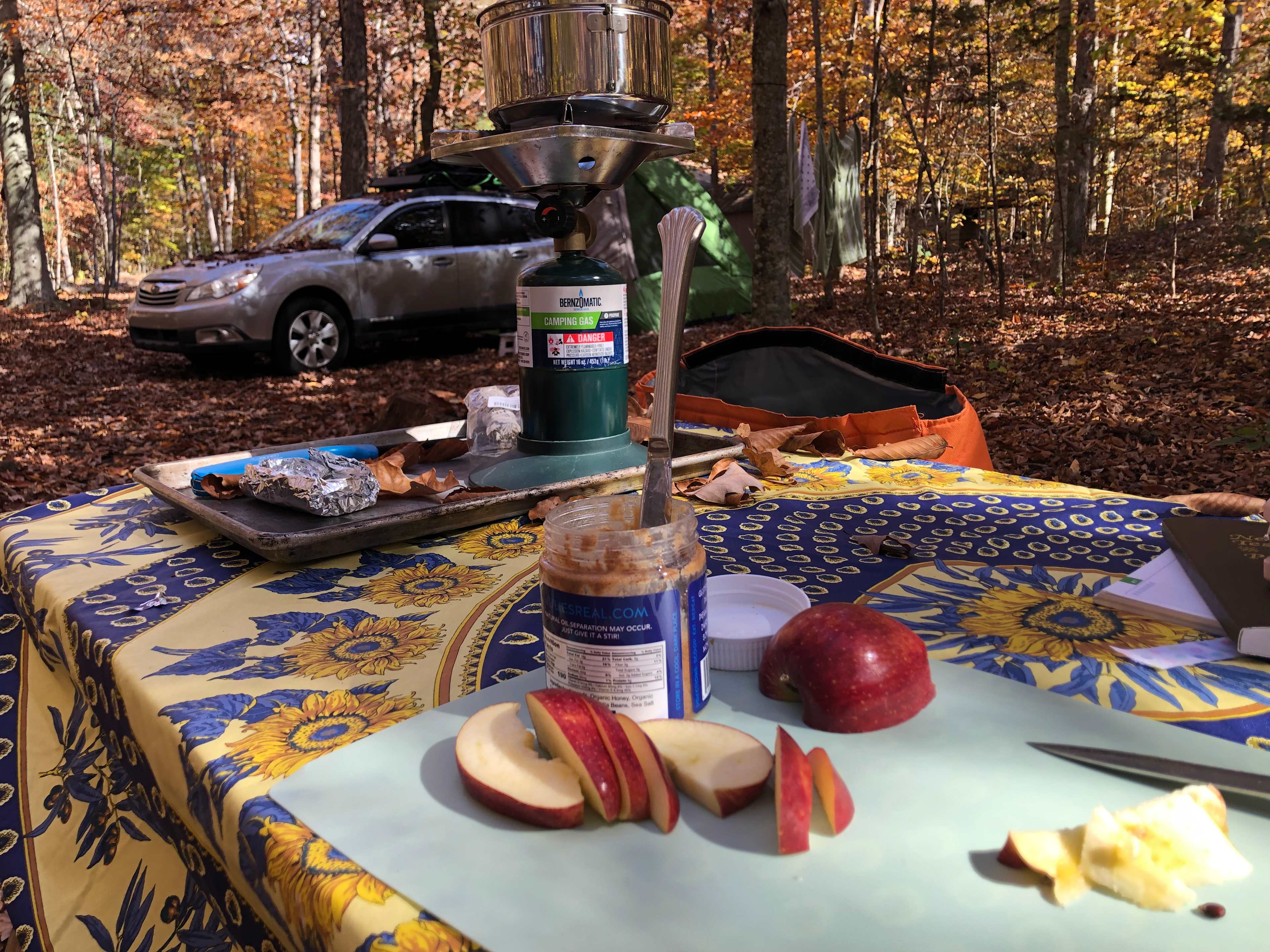 Breakfast, with car/tent camping set-up and bathhouse in background.