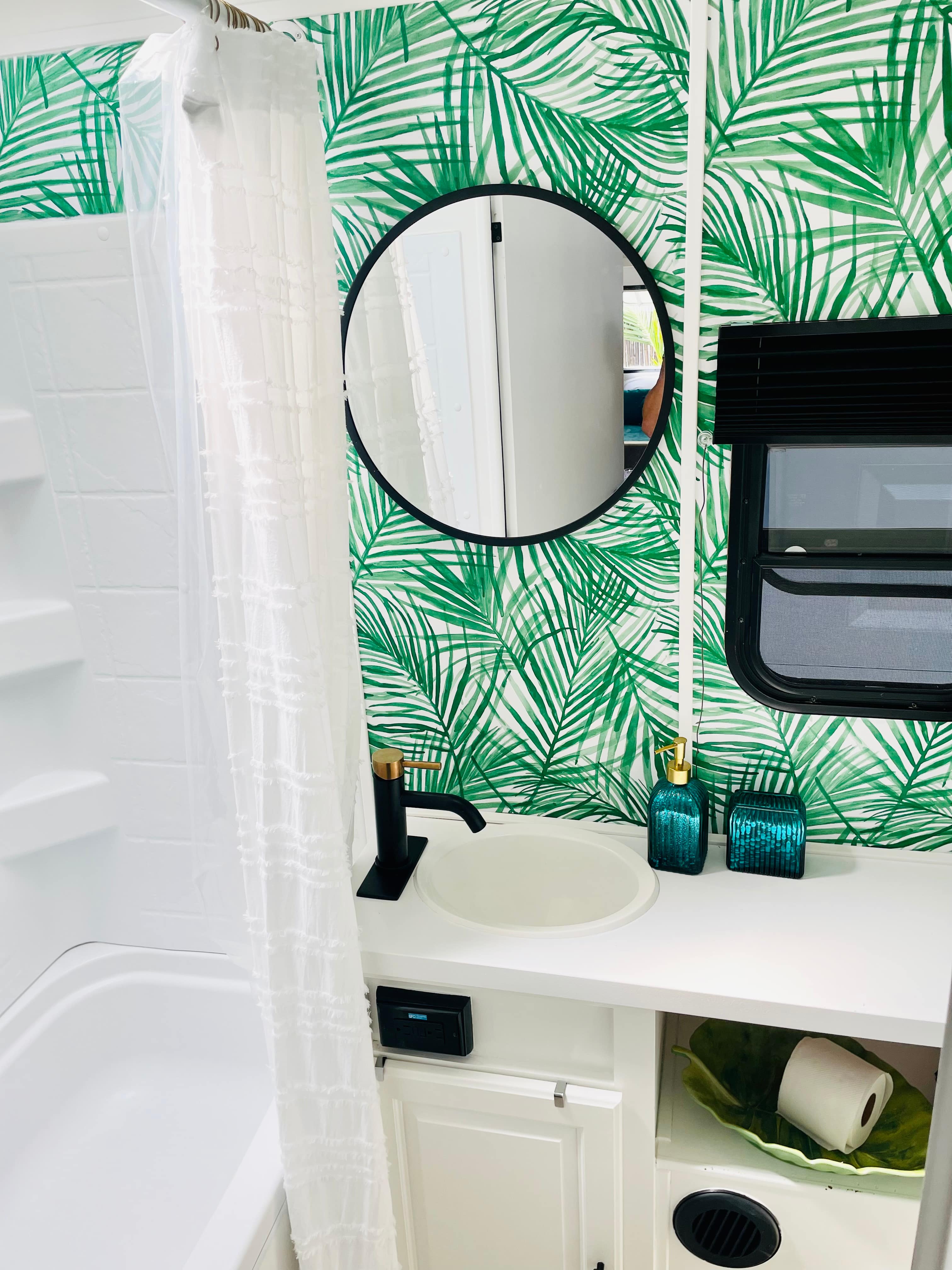 Bathroom with shower, small bath, and toilet.