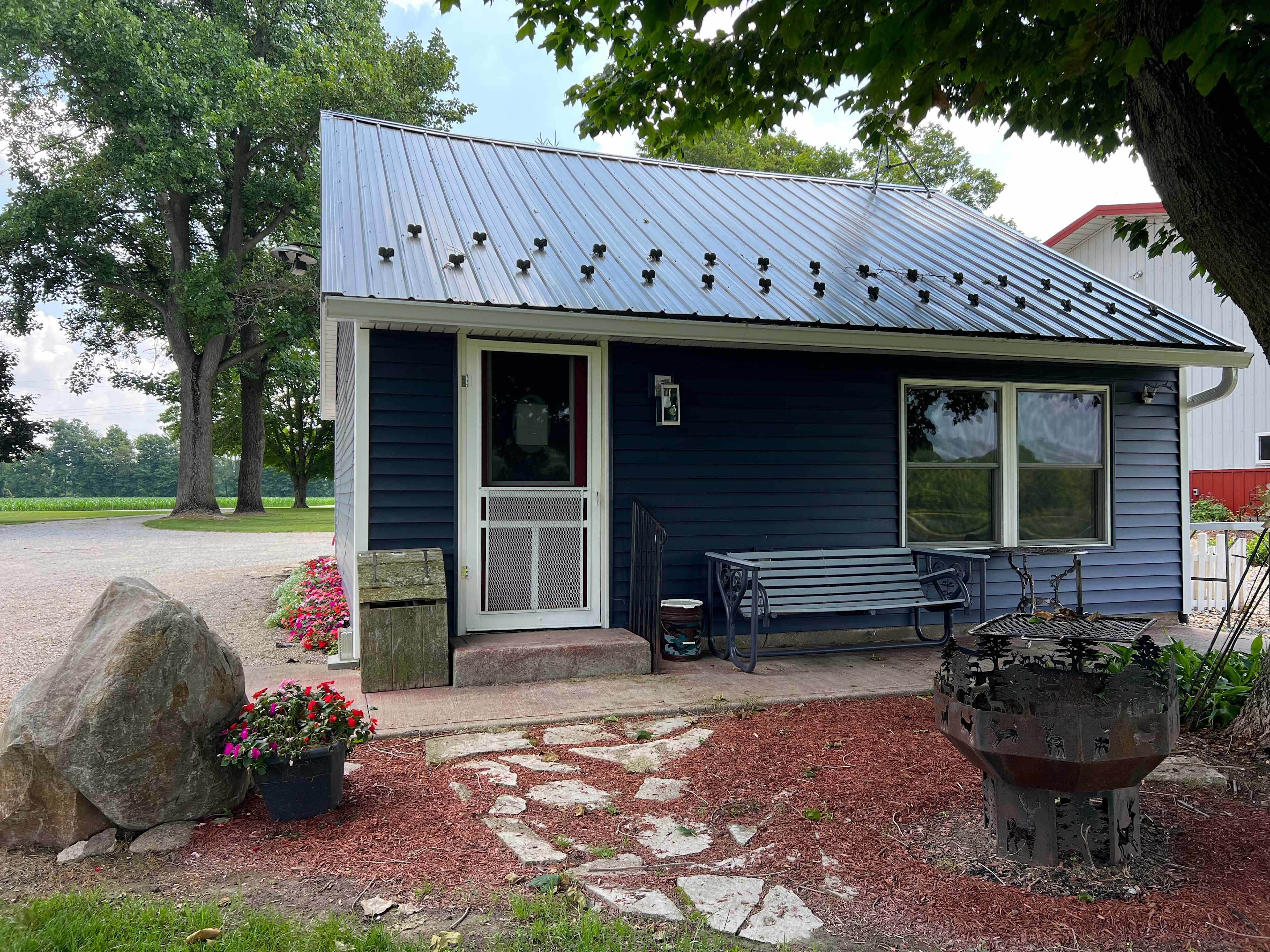 Your 500 square-foot private Bunkhouse. Sit here on your patio and enjoy a beautiful sunset. If you choose to grill out on the Blackstone griddle, you can also take advantage of a beautiful field, lake and woods view.