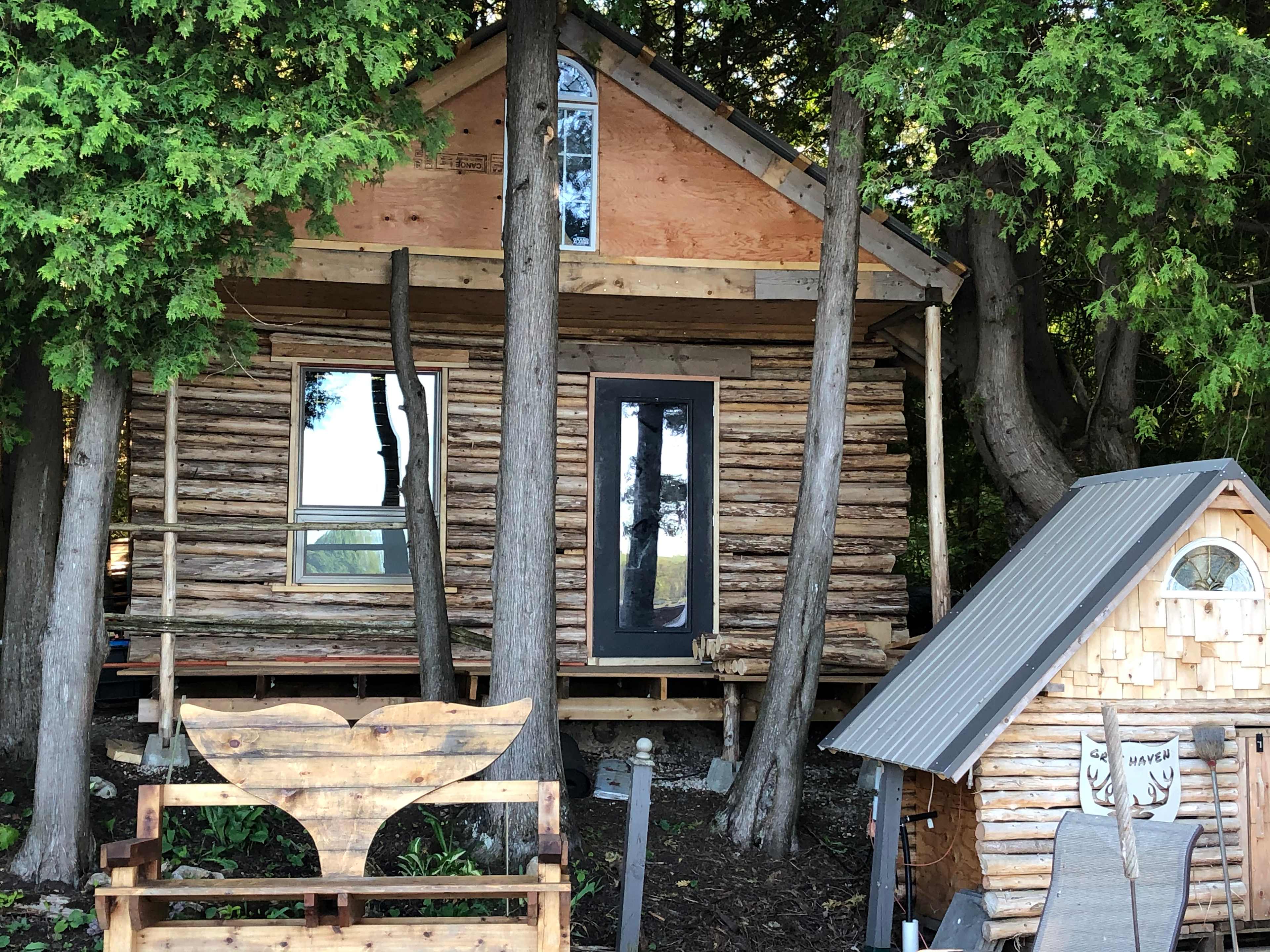 The Lakefront Log Cabin and whale bench