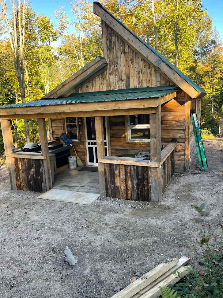 Covered porch with BBQ and cookstove (in summer) And table and chairs for outdoor dining.
