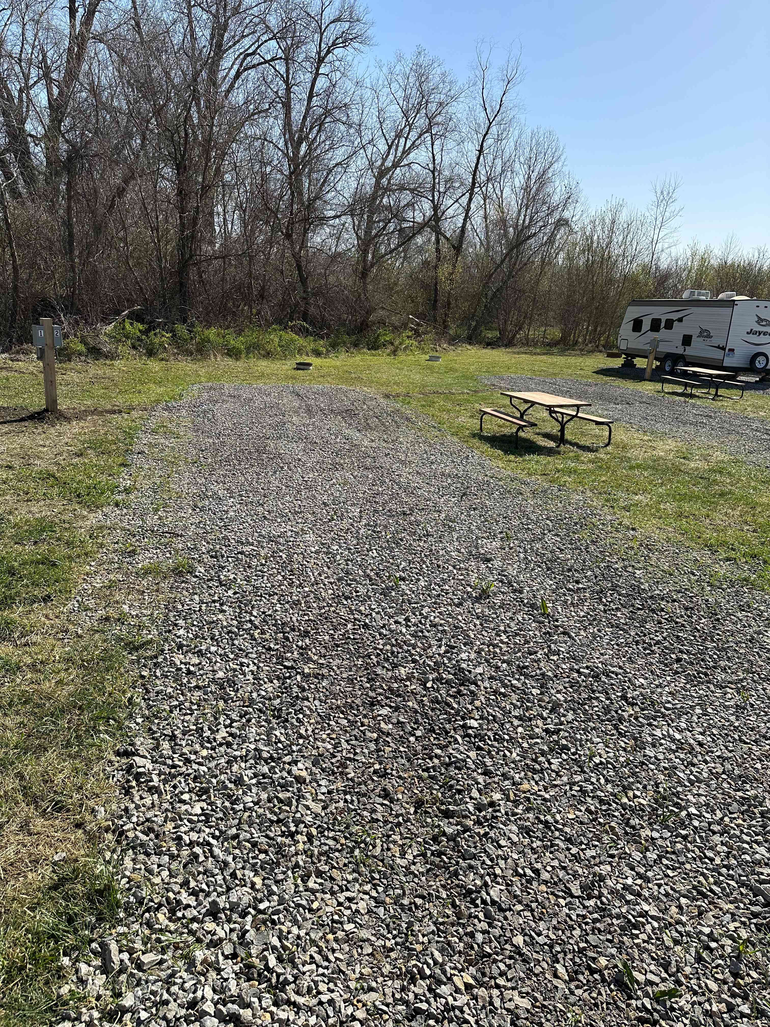 Deep site, slightly down sloping. Drive in with picnic table ans fire ring. Will likely need extension cord. 