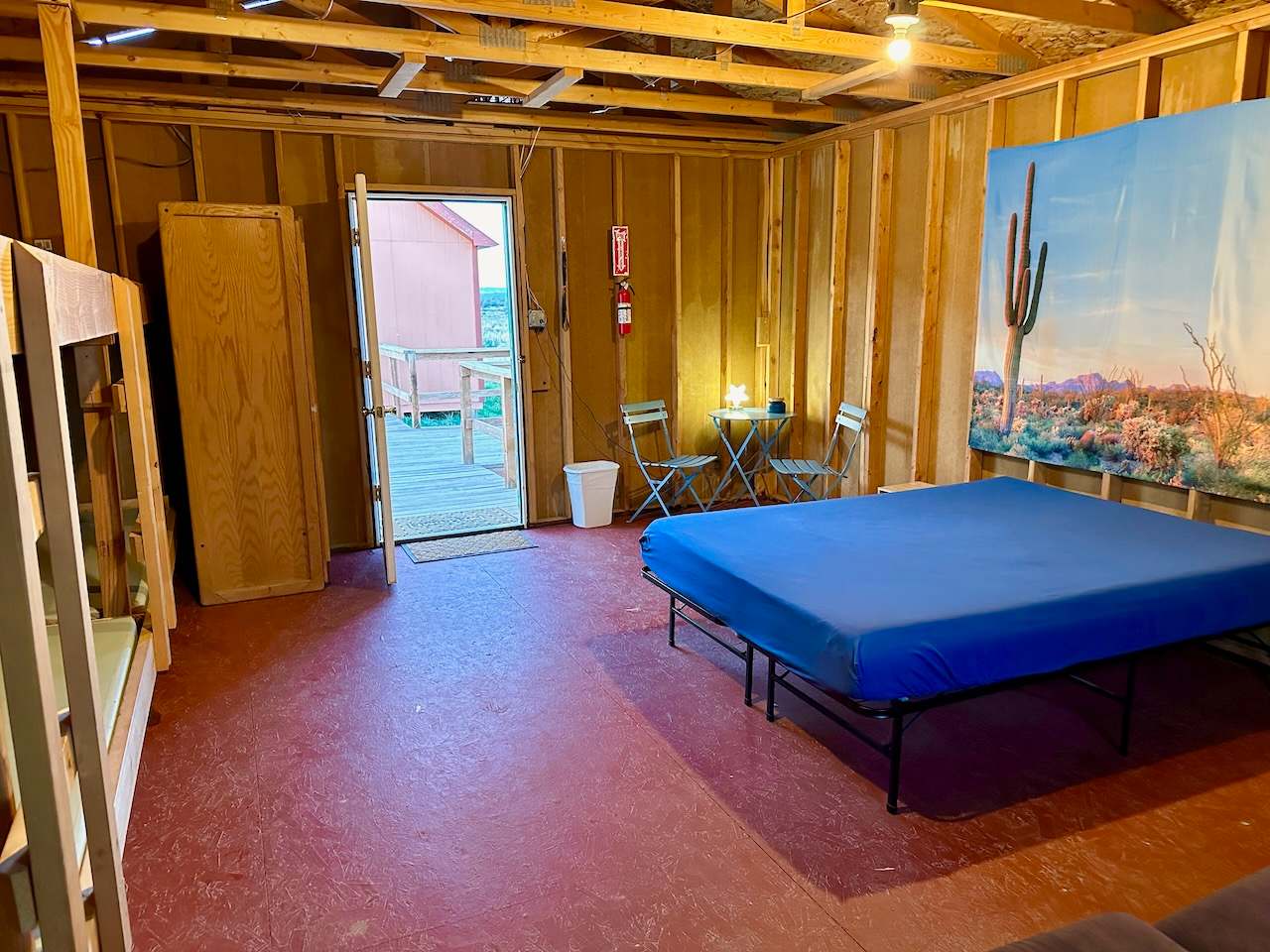 SKY Bunkhouse is 400 sf with six bunks.  The Queen bed comes with a matress pad and clean fitted sheet.  You can rent:  Pillows, Comforter, Sheets & 2 Towels and Camper Sets for the bunks if needed.  It has electricity & fans, no AC or Heat.  
