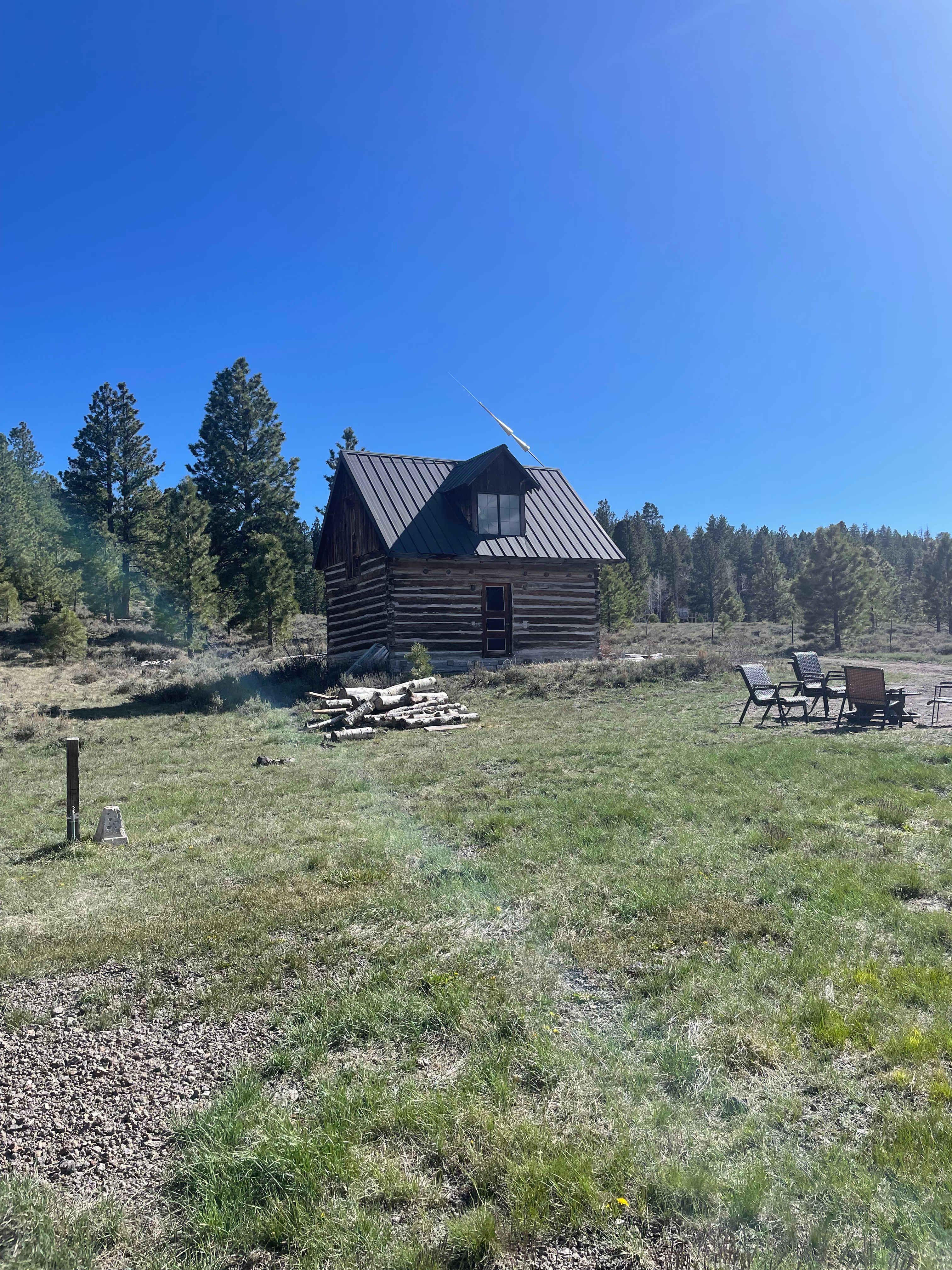 Full RV Hookup, and tent site on grass area near wood pile. Building shown is unoccupied. 																			